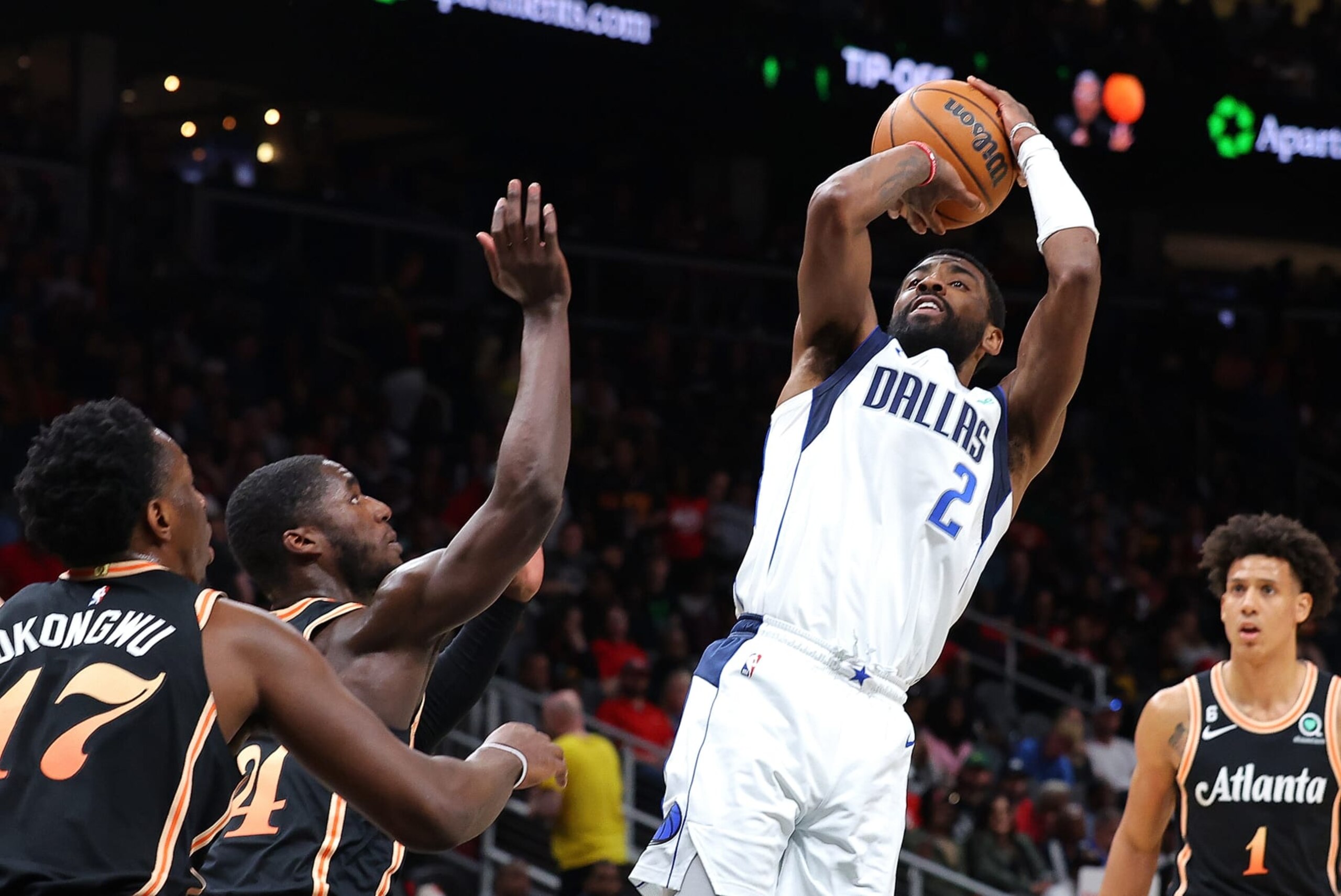 ATLANTA, GEORGIA - APRIL 02:  Kyrie Irving #2 of the Dallas Mavericks shoots against AJ Griffin #14 and Onyeka Okongwu #17 of the Atlanta Hawks during the second quarter at State Farm Arena on April 02, 2023 in Atlanta, Georgia.  NOTE TO USER: User expressly acknowledges and agrees that, by downloading and or using this photograph, User is consenting to the terms and conditions of the Getty Images License Agreement.  (Photo by Kevin C. Cox/Getty Images)