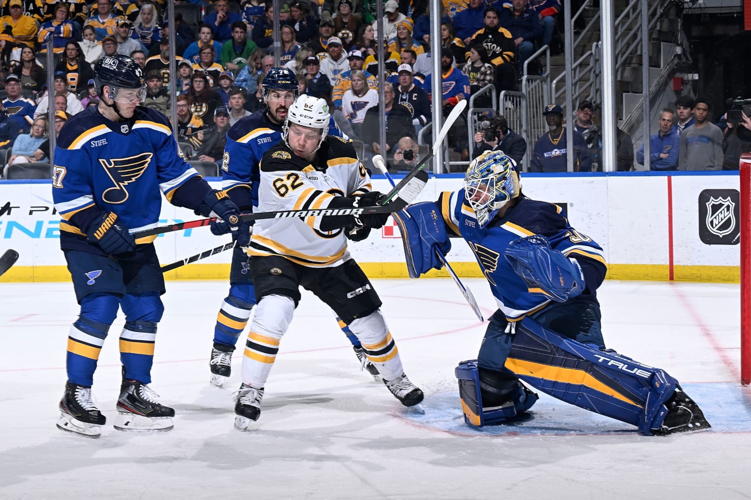 ST. LOUIS, MO - APRIL 2: Torey Krug #47 and Jordan Binnington #50 of the St. Louis Blues defend the net against Oskar Steen #62 of the Boston Bruins at the Enterprise Center on April 2, 2023 in St. Louis, Missouri. (Photo by Scott RovakNHLI via Getty Images)
