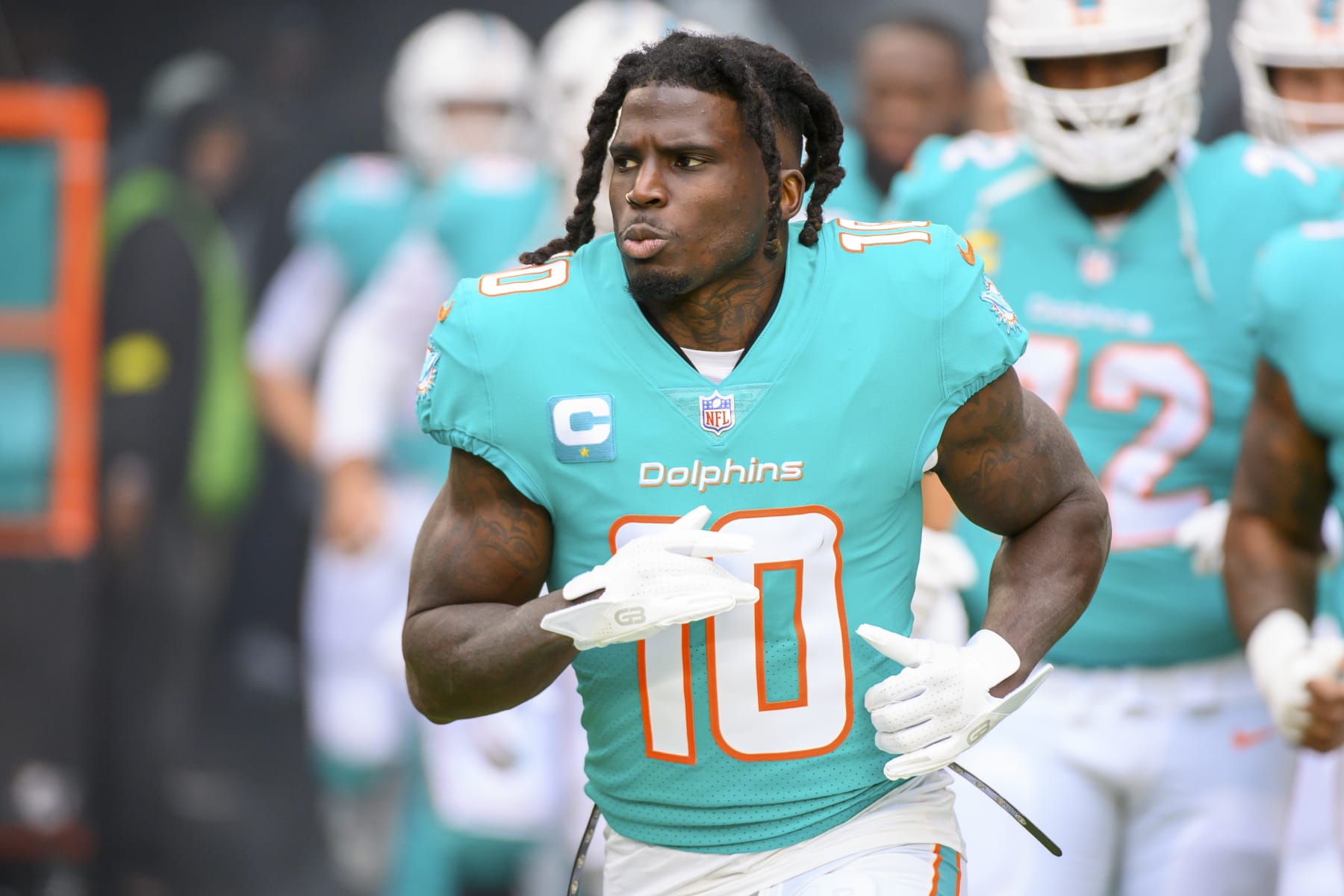 Miami Dolphins wide receiver Tyreek Hill (10) runs onto the field before an NFL football game against the Green Bay Packers, Sunday, Dec. 25, 2022, in Miami Gardens, Fla. (AP Photo/Doug Murray)