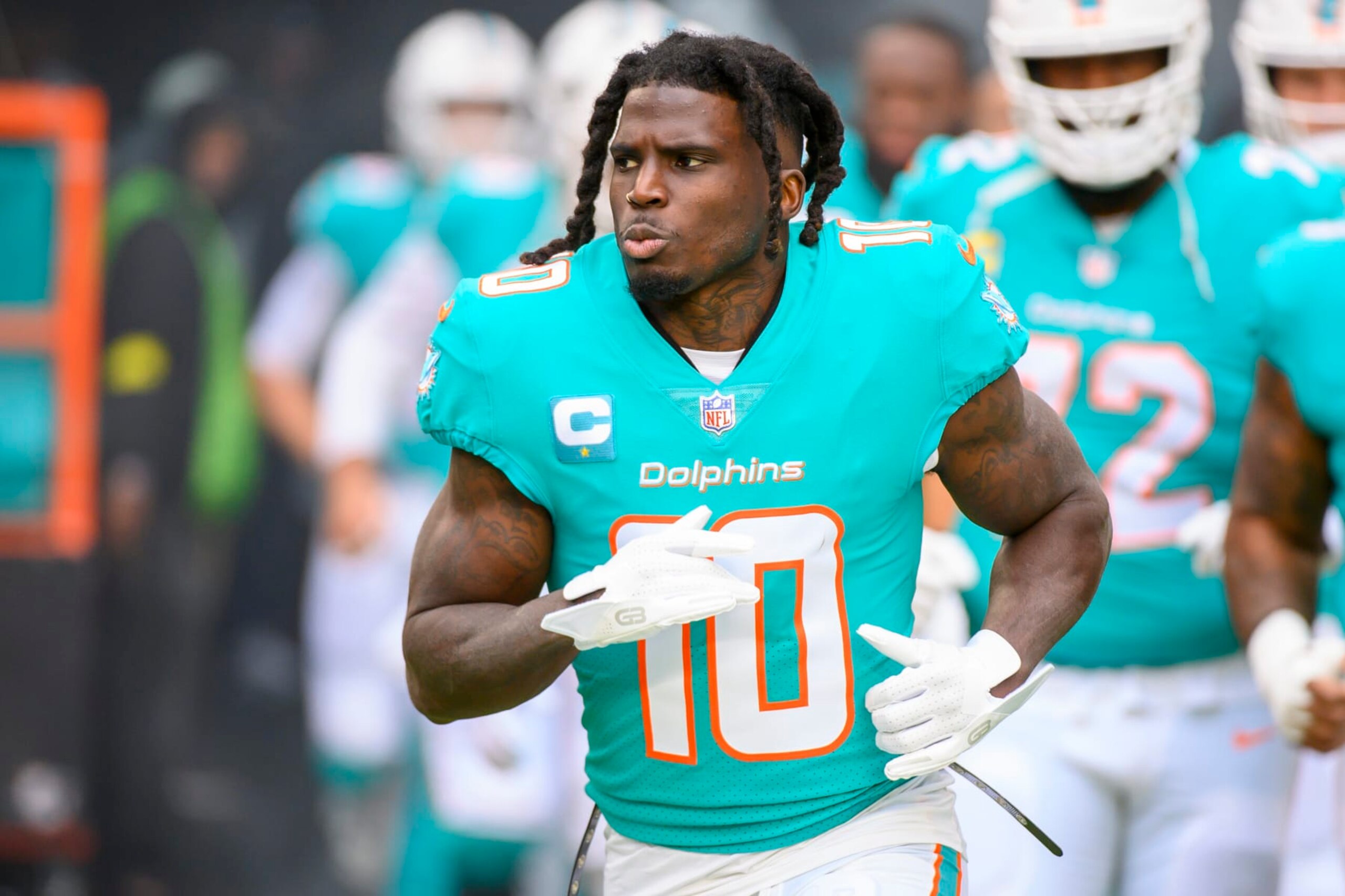 Miami Dolphins wide receiver Tyreek Hill (10) runs onto the field before an NFL football game against the Green Bay Packers, Sunday, Dec. 25, 2022, in Miami Gardens, Fla. (AP Photo/Doug Murray)