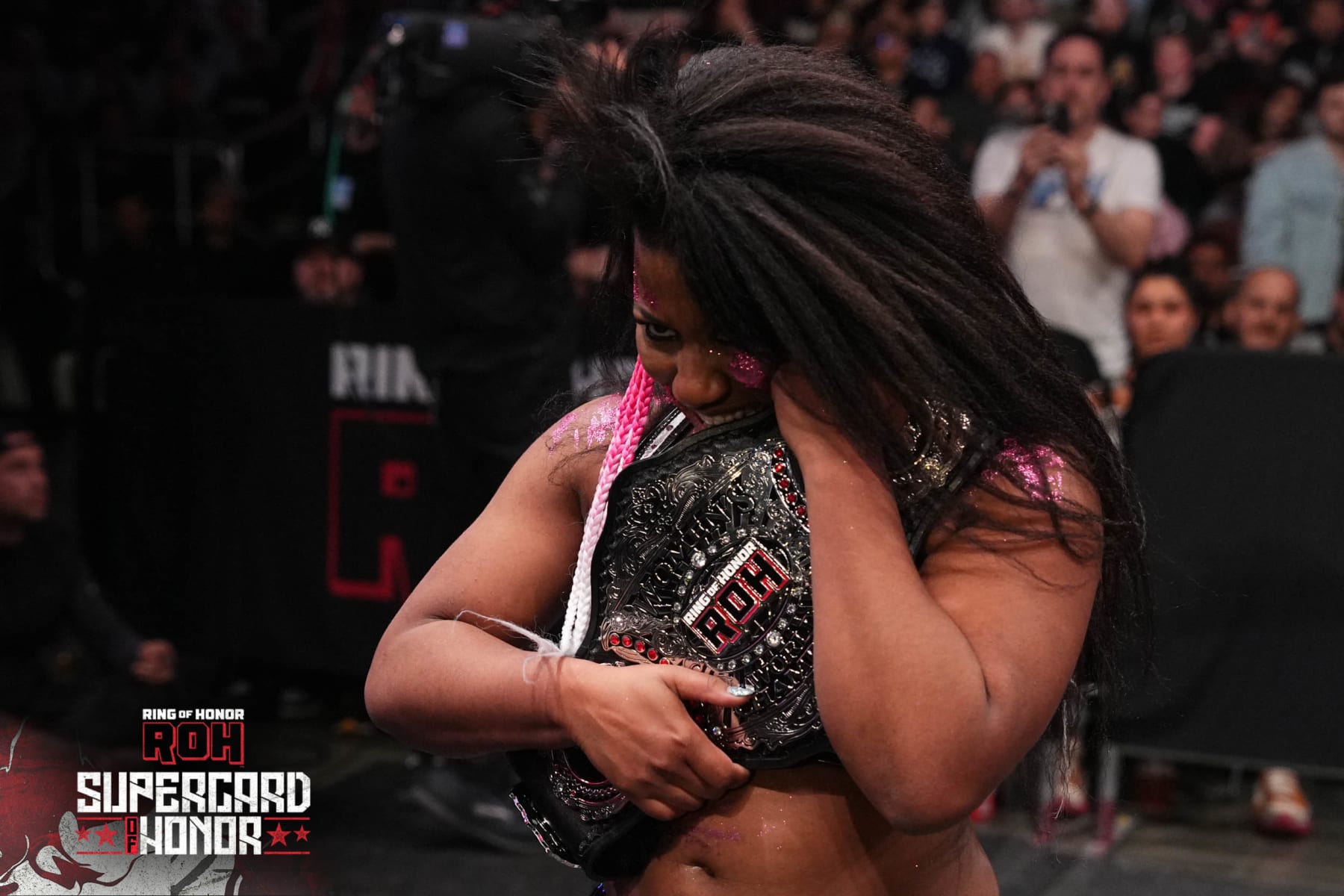 Athena holding the ROH Women's Championship.