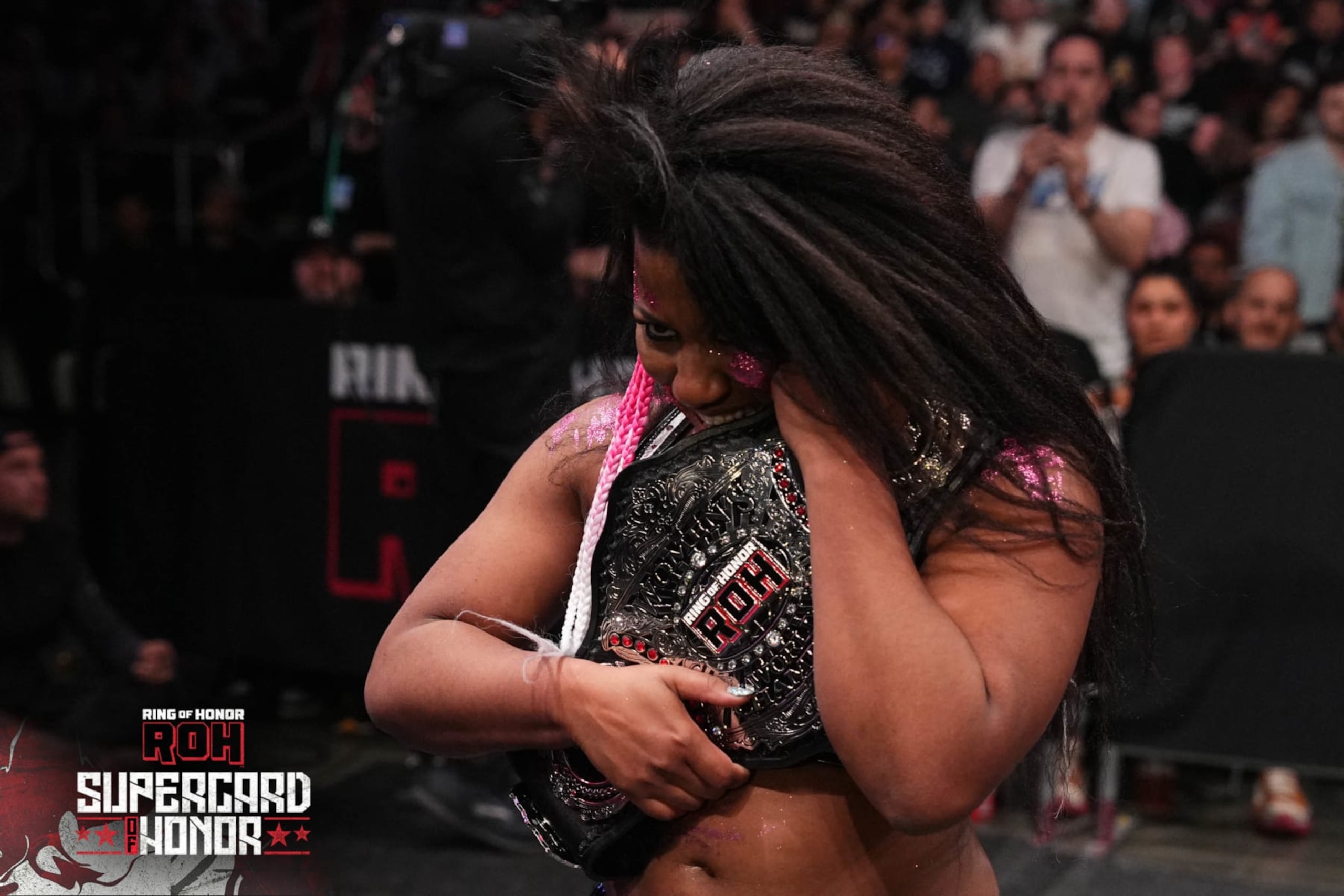 Athena holding the ROH Women's Championship.