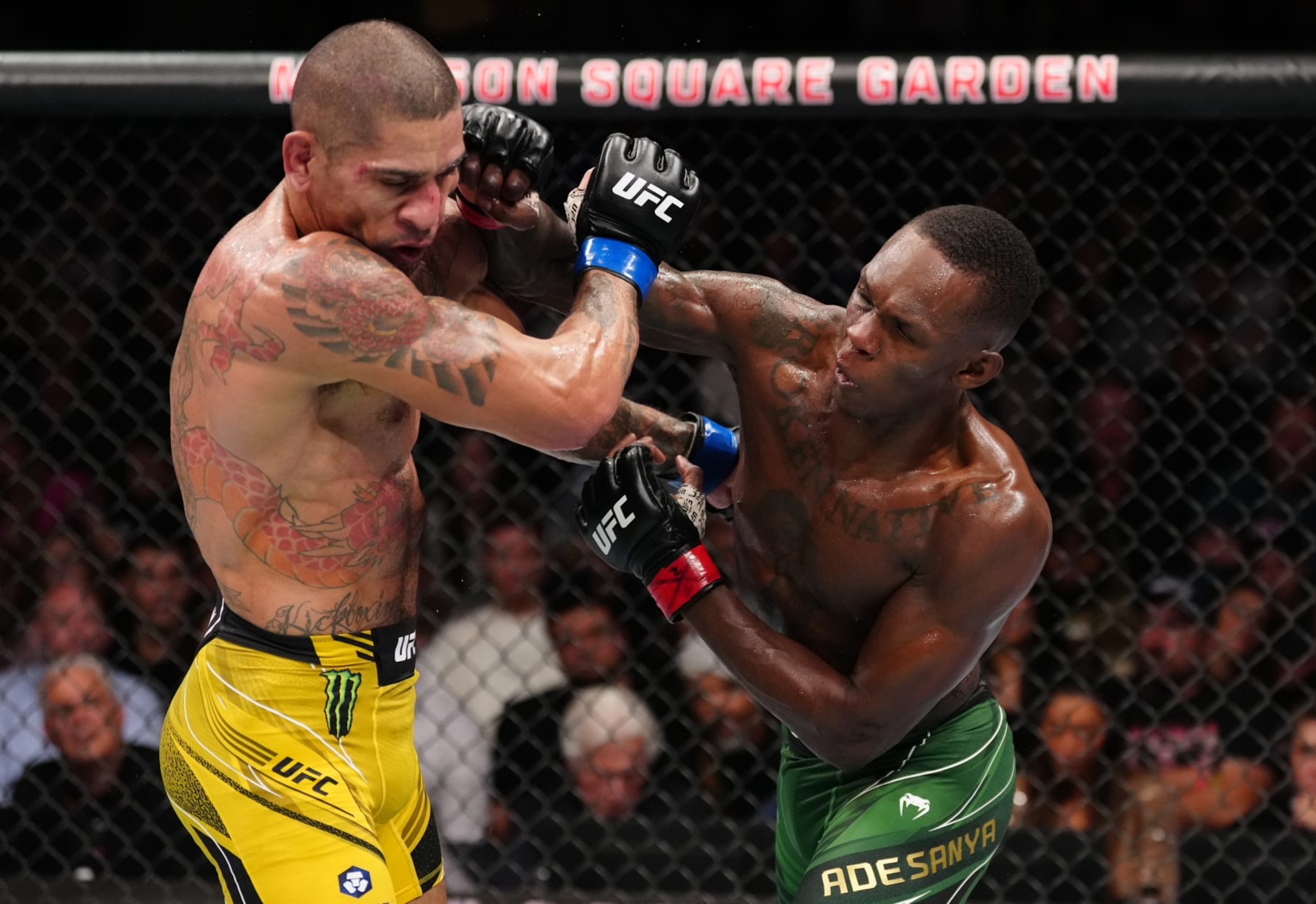 Israel Adesanya (right) lands a punch on Alex Pereira. 