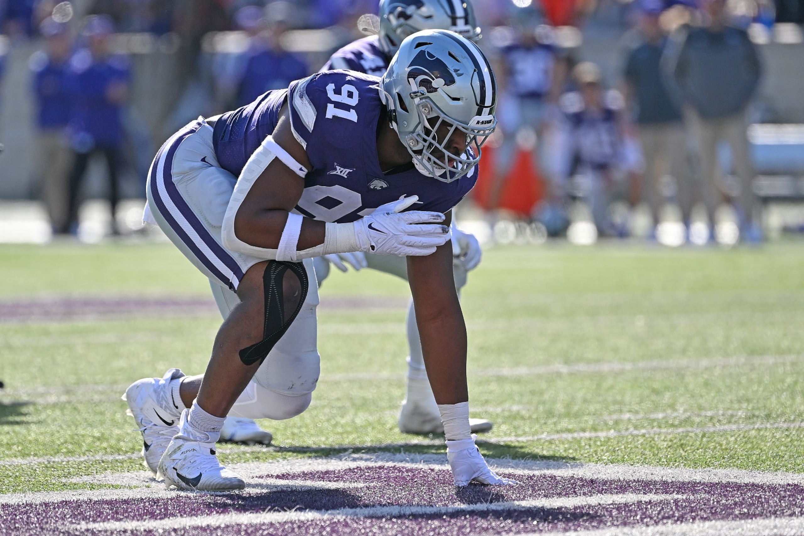 MANHATTAN, KS - OCTOBER 29:  Defensive end Felix Anudike-Uzomah #91 of the Kansas State Wildcats gets set on defense against the Oklahoma State Cowboys during the first half at Bill Snyder Family Football Stadium on October 29, 2022 in Manhattan, Kansas. (Photo by Peter G. Aiken/Getty Images)