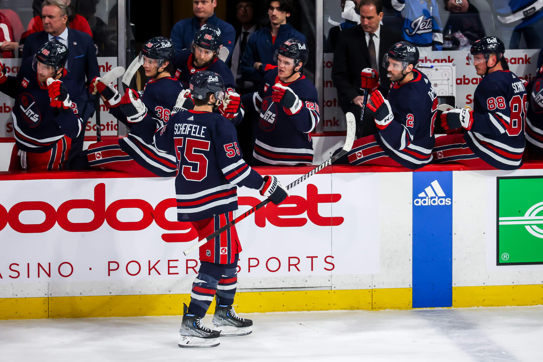 WINNIPEG, CANADA - MARCH 31: Mark Scheifele #55 of the Winnipeg Jets celebrates his first period goal against the Detroit Red Wings with teammates at the bench at the Canada Life Centre on March 31, 2023 in Winnipeg, Manitoba, Canada. (Photo by Jonathan Kozub/NHLI via Getty Images)