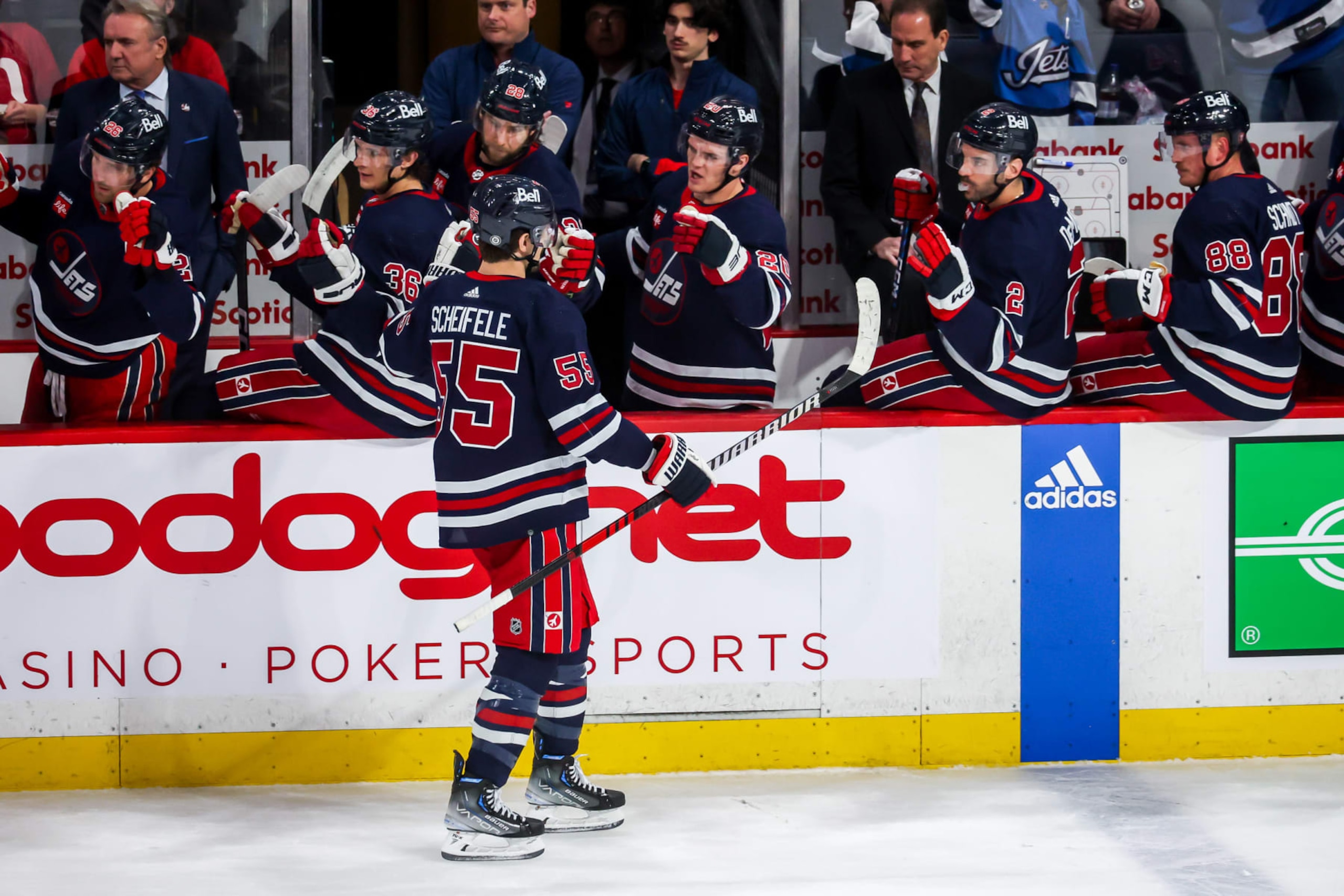 WINNIPEG, CANADA - MARCH 31: Mark Scheifele #55 of the Winnipeg Jets celebrates his first period goal against the Detroit Red Wings with teammates at the bench at the Canada Life Centre on March 31, 2023 in Winnipeg, Manitoba, Canada. (Photo by Jonathan Kozub/NHLI via Getty Images)
