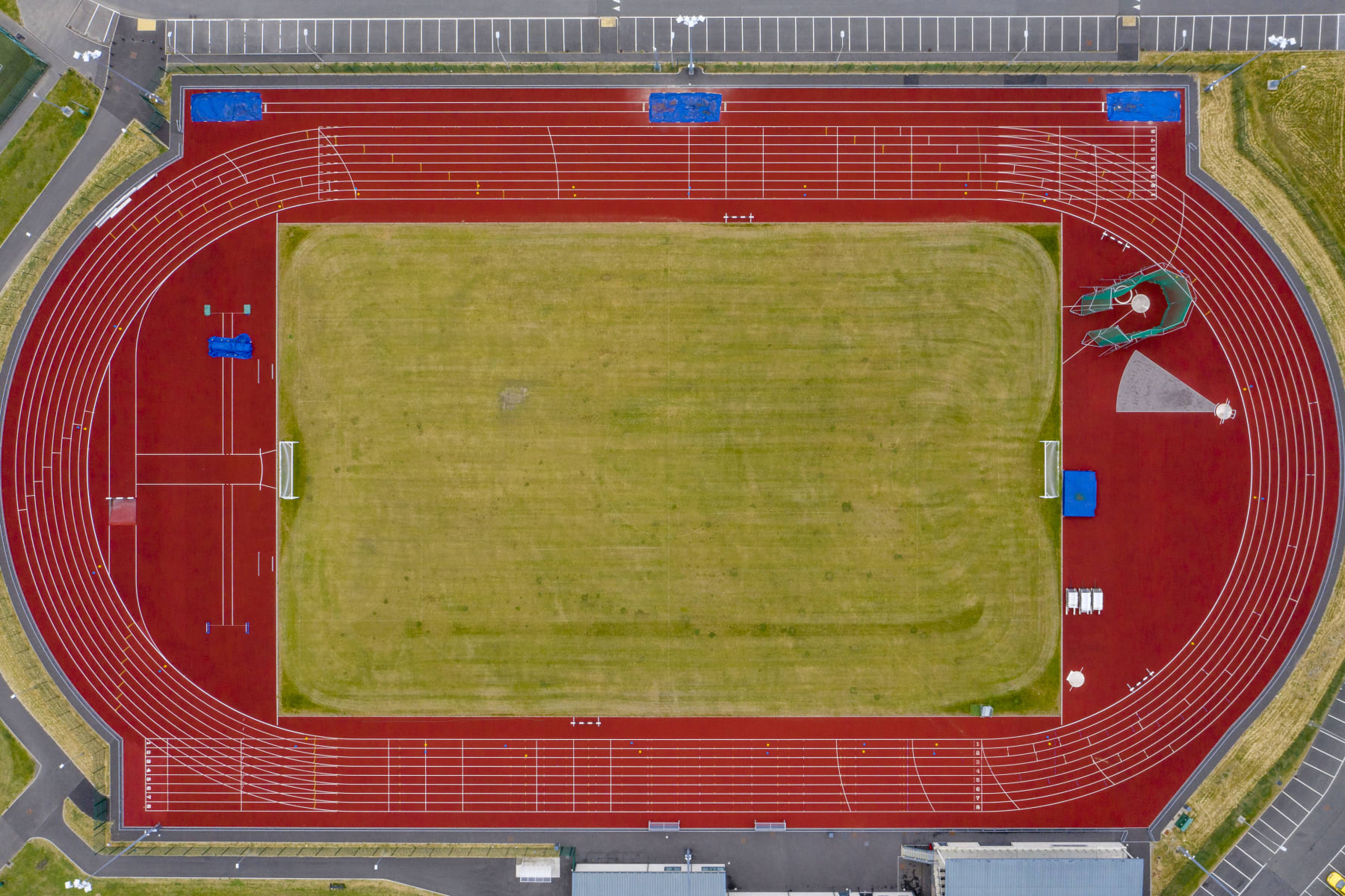 ABERDARE, UNITED KINGDOM - JUNE 10: An aerial view of an empty athletics track and field on June 10, 2020 in Aberdare, United Kingdom. The Welsh government has further relaxed COVID-19 lockdown measures this week, allowing people from different households to meet up outside while maintaining social distancing. Schools have remained closed and those who have been advised to shield at home can go outside again but have been told to avoid shopping. (Photo by Matthew Horwood/Getty Images)