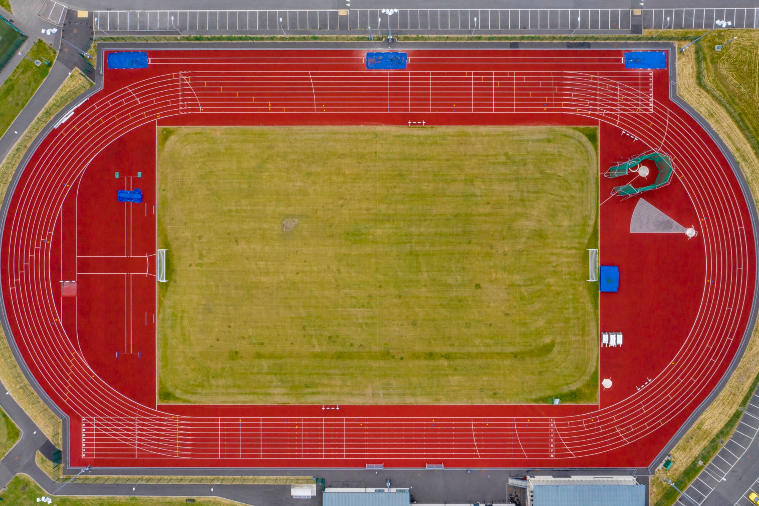ABERDARE, UNITED KINGDOM - JUNE 10: An aerial view of an empty athletics track and field on June 10, 2020 in Aberdare, United Kingdom. The Welsh government has further relaxed COVID-19 lockdown measures this week, allowing people from different households to meet up outside while maintaining social distancing. Schools have remained closed and those who have been advised to shield at home can go outside again but have been told to avoid shopping. (Photo by Matthew Horwood/Getty Images)