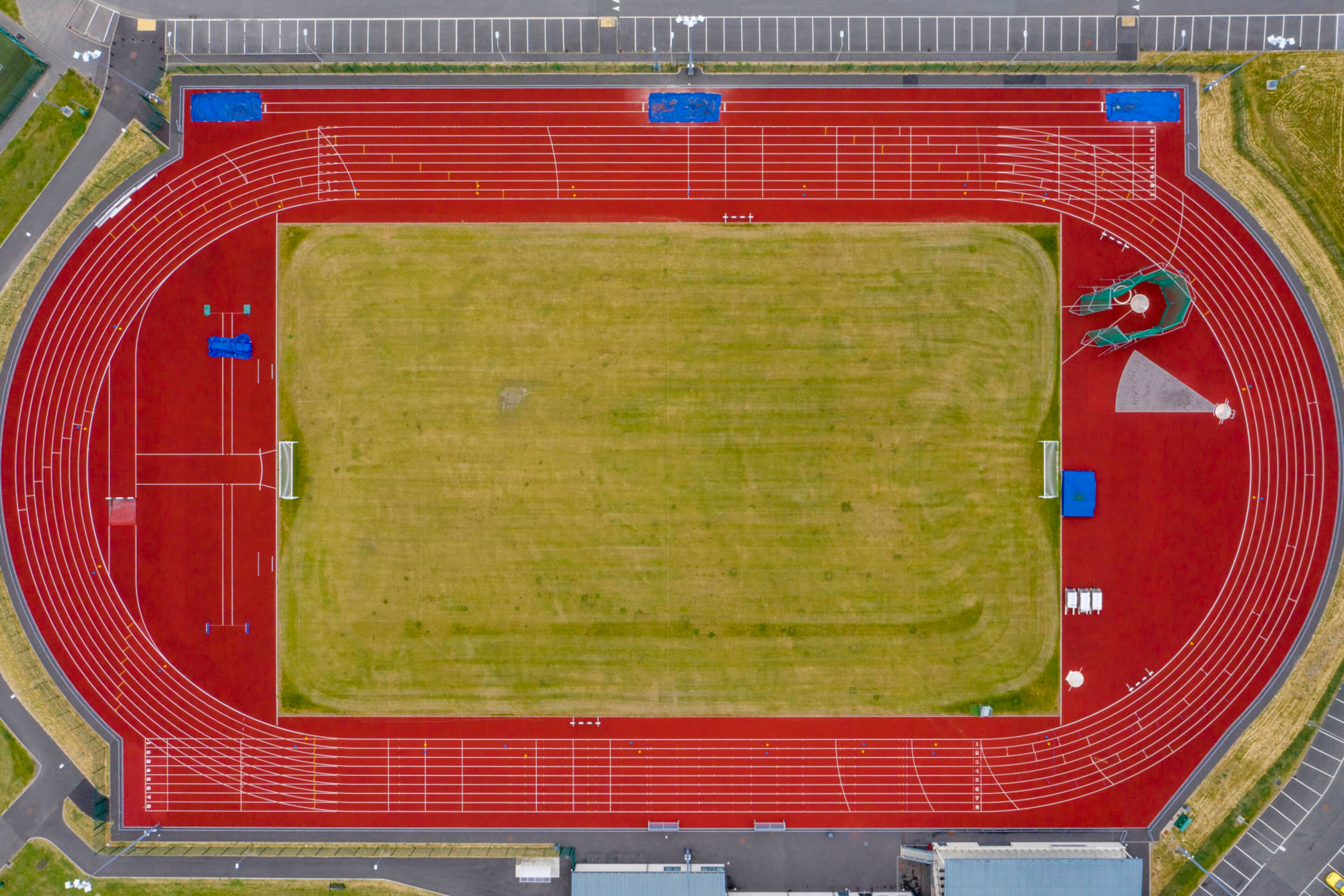 ABERDARE, UNITED KINGDOM - JUNE 10: An aerial view of an empty athletics track and field on June 10, 2020 in Aberdare, United Kingdom. The Welsh government has further relaxed COVID-19 lockdown measures this week, allowing people from different households to meet up outside while maintaining social distancing. Schools have remained closed and those who have been advised to shield at home can go outside again but have been told to avoid shopping. (Photo by Matthew Horwood/Getty Images)