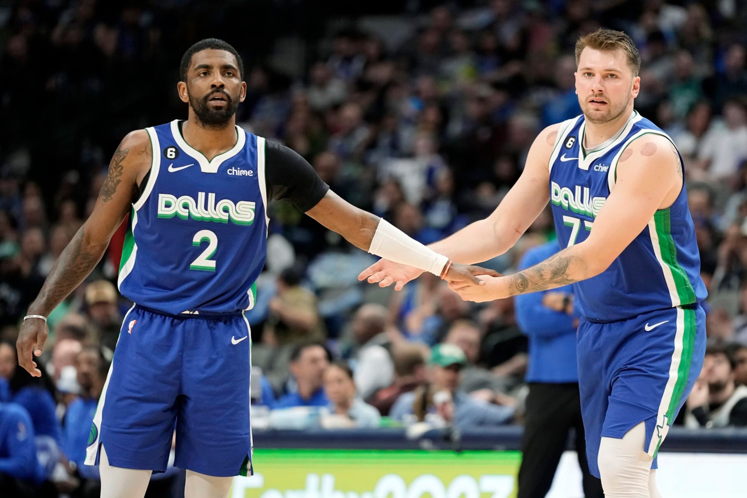 DALLAS, TEXAS - MARCH 24: Kyrie Irving #2 of the Dallas Mavericks congratulates Luka Doncic #77 during the first half against the Charlotte Hornets at American Airlines Center on March 24, 2023 in Dallas, Texas. NOTE TO USER: User expressly acknowledges and agrees that, by downloading and/or using this Photograph, user is consenting to the terms and conditions of the Getty Images License Agreement. (Photo by Sam Hodde/Getty Images)