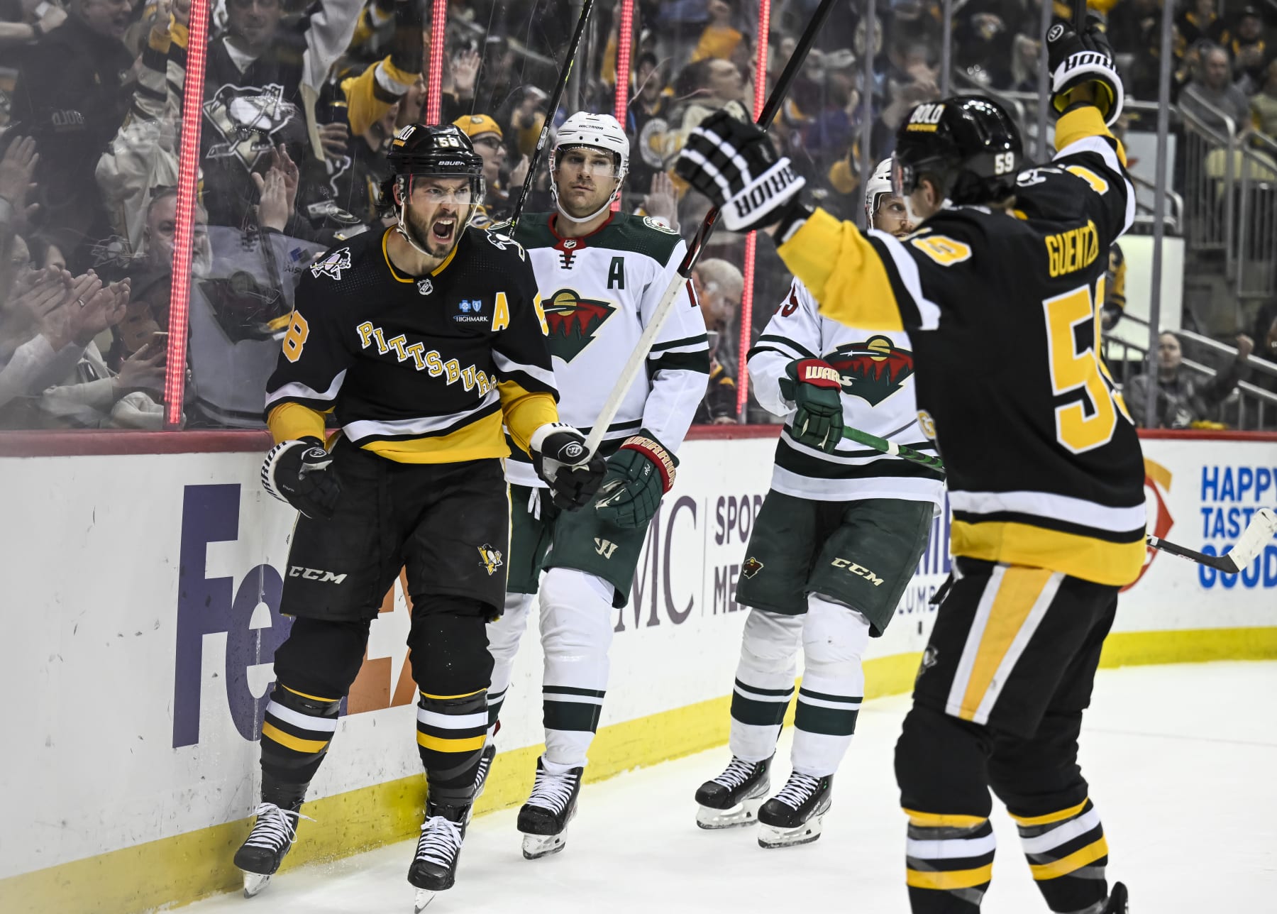 PITTSBURGH, PA - APRIL 06: Pittsburgh Penguins defenseman Kris Letang (58) celebrates his goal with Pittsburgh Penguins left wing Jake Guentzel (59) during the first period in the NHL game between the Pittsburgh Penguins and the Minnesota Wild on April 6, 2023, at PPG Paints Arena in Pittsburgh, PA. (Photo by Jeanine Leech/Icon Sportswire via Getty Images)