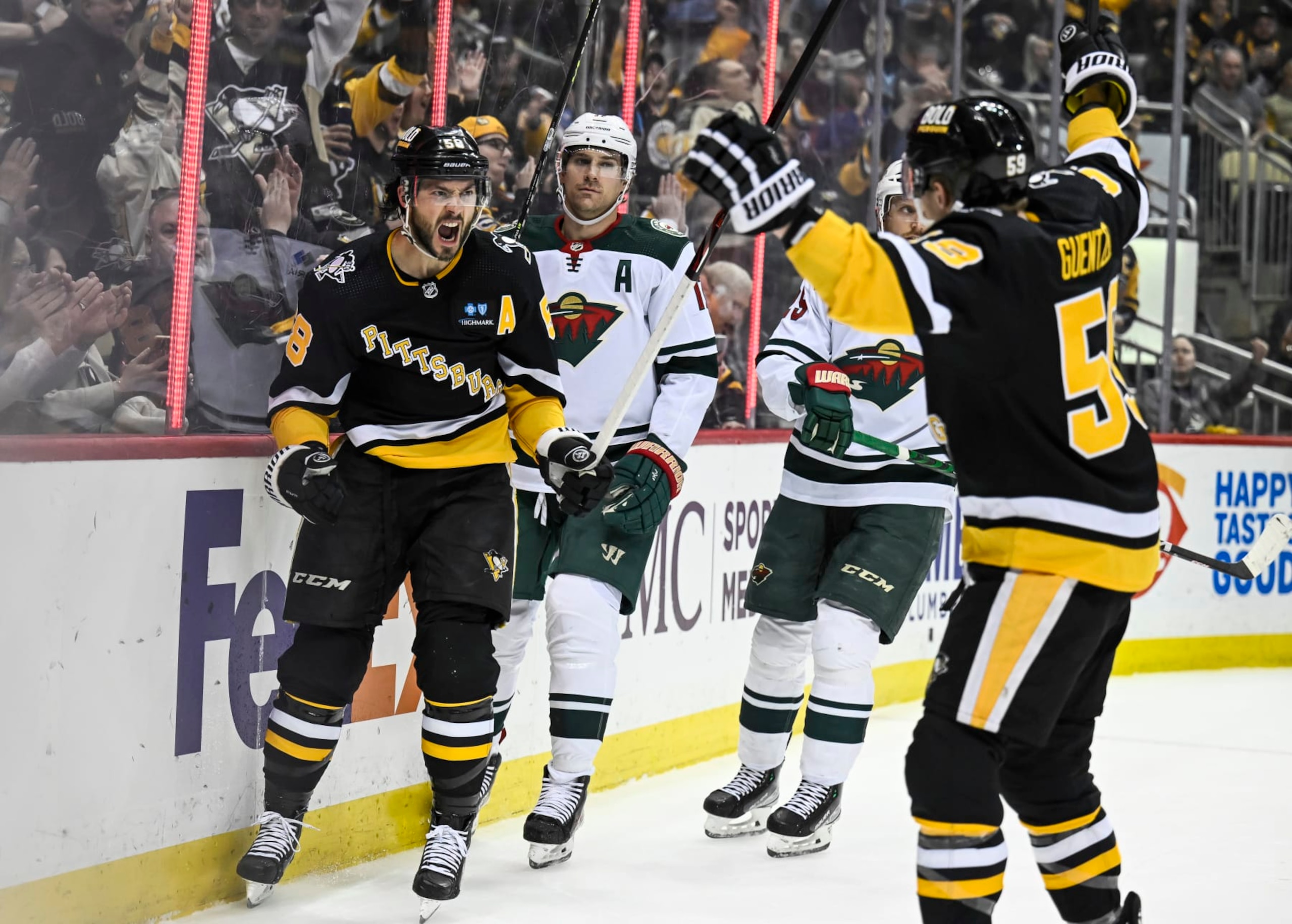PITTSBURGH, PA - APRIL 06: Pittsburgh Penguins defenseman Kris Letang (58) celebrates his goal with Pittsburgh Penguins left wing Jake Guentzel (59) during the first period in the NHL game between the Pittsburgh Penguins and the Minnesota Wild on April 6, 2023, at PPG Paints Arena in Pittsburgh, PA. (Photo by Jeanine Leech/Icon Sportswire via Getty Images)