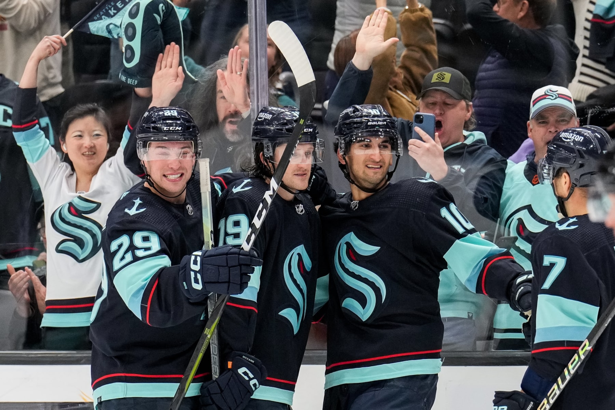 SEATTLE, WASHINGTON - APRIL 6:Vince Dunn #29, Jared McCann #19, Matty Beniers #10 and Jordan Eberle #7 of the Seattle Kraken celebrate a goal by Beniers against the Arizona Coyotes during the third period at Climate Pledge Arena on April 6 2023 in Seattle, Washington. (Photo by Christopher Mast/NHLI via Getty Images)