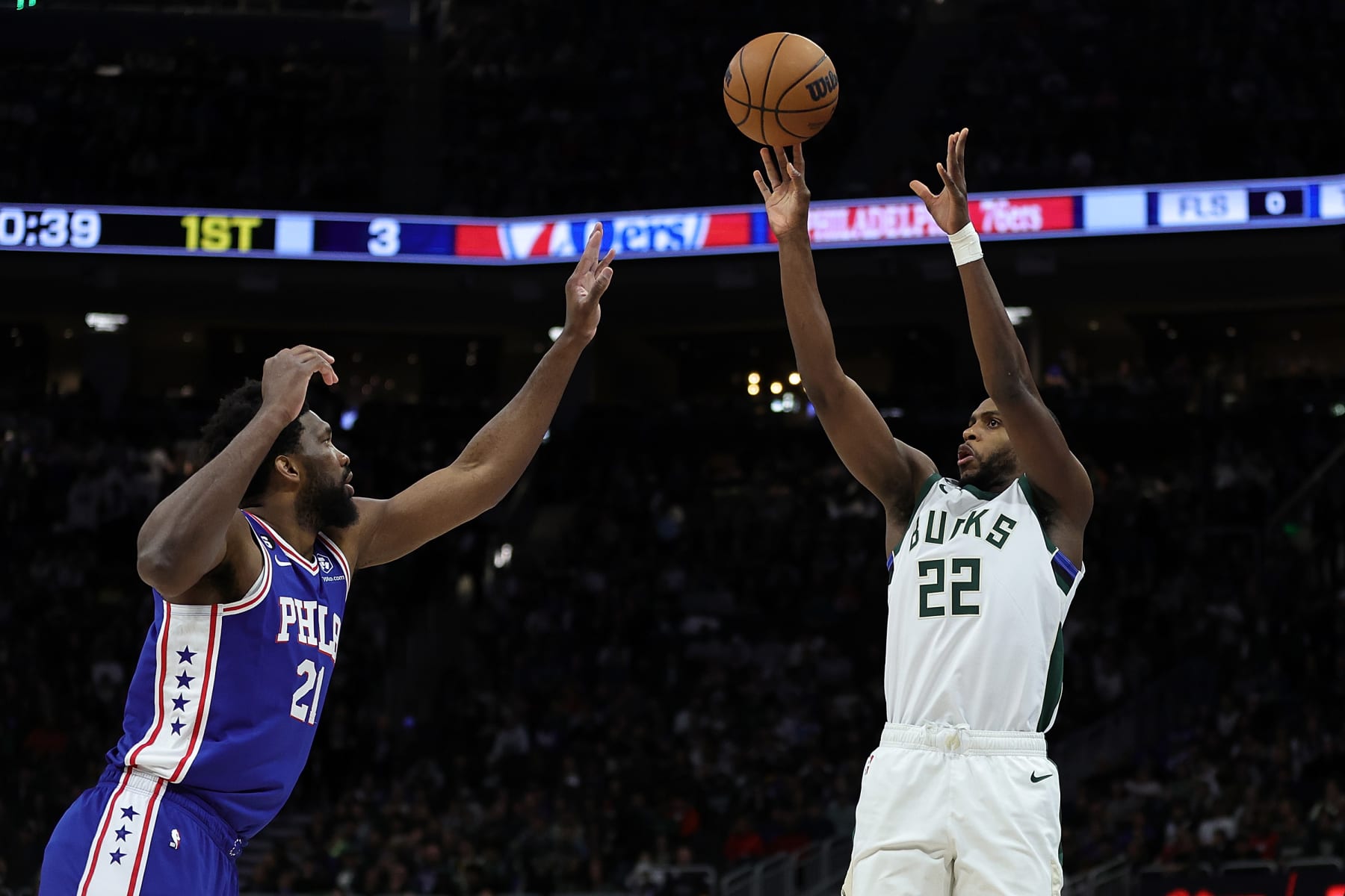 MILWAUKEE, WISCONSIN - APRIL 02: Khris Middleton #22 of the Milwaukee Bucks shoots over Joel Embiid #21 of the Philadelphia 76ers during the first half of a game at Fiserv Forum on April 02, 2023 in Milwaukee, Wisconsin. NOTE TO USER: User expressly acknowledges and agrees that, by downloading and or using this photograph, User is consenting to the terms and conditions of the Getty Images License Agreement. (Photo by Stacy Revere/Getty Images)