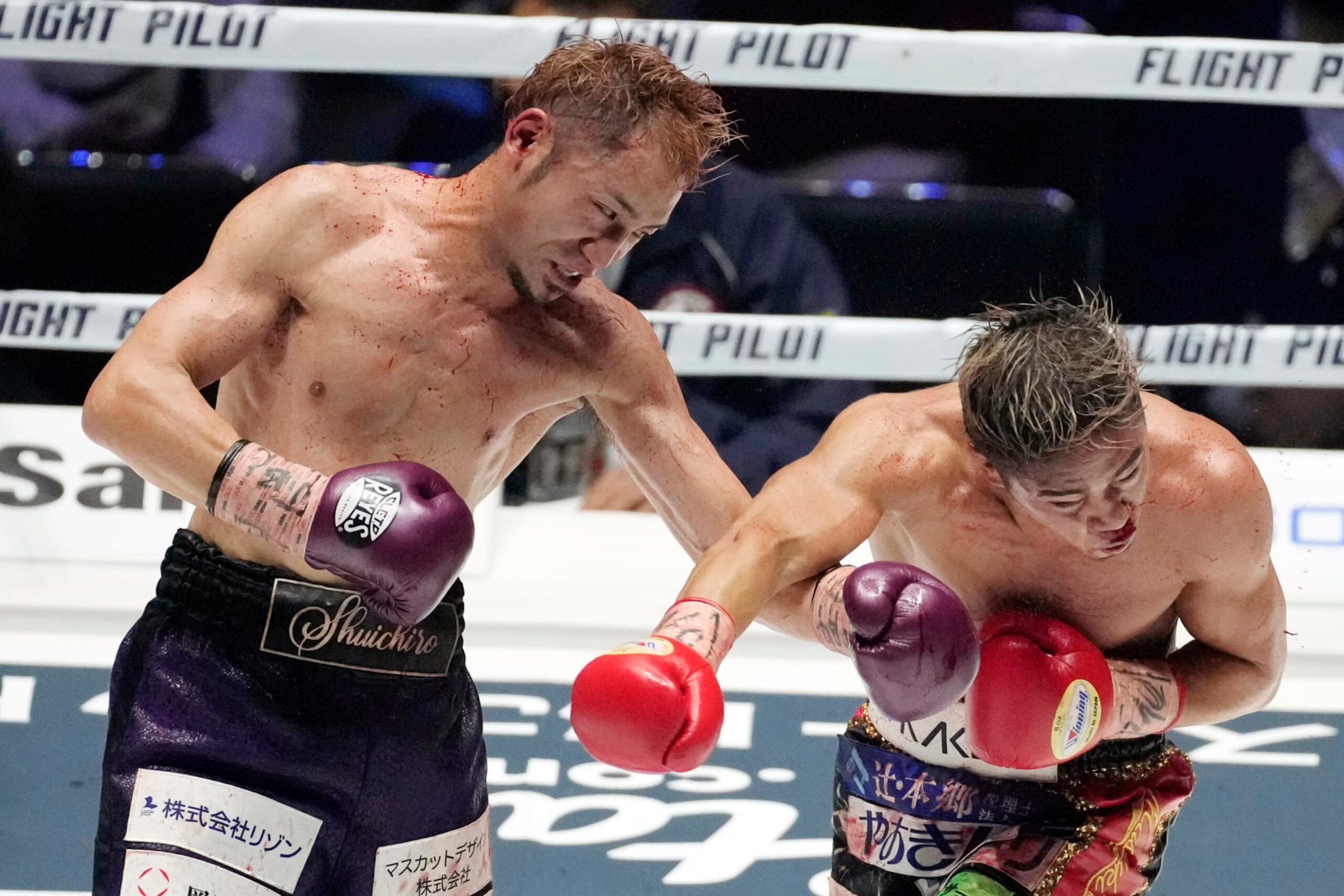 Japan's Shuichiro Yoshino sends a left to compatriot Masayuki Ito during their WBO Asia Pacific and OPBF lightweight championship match in Saitama, near Tokyo, Saturday, April 9, 2022. (AP Photo/Shuji Kajiyama)
