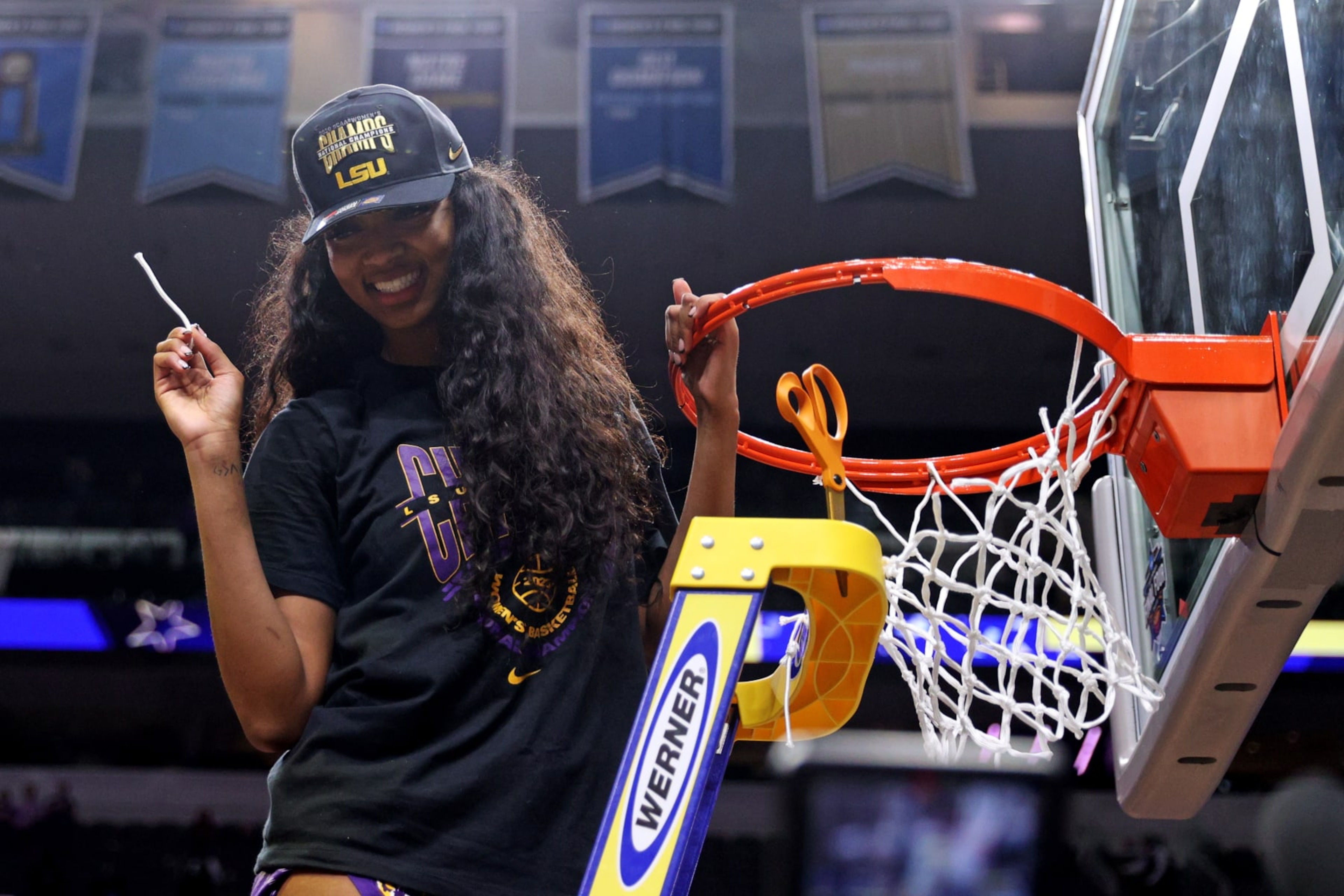 DALLAS, TEXAS - APRIL 02: Angel Reese #10 of the LSU Lady Tigers cuts down a piece of the net after defeating the Iowa Hawkeyes 102-85 during the 2023 NCAA Women's Basketball Tournament championship game at American Airlines Center on April 02, 2023 in Dallas, Texas. (Photo by Maddie Meyer/Getty Images)