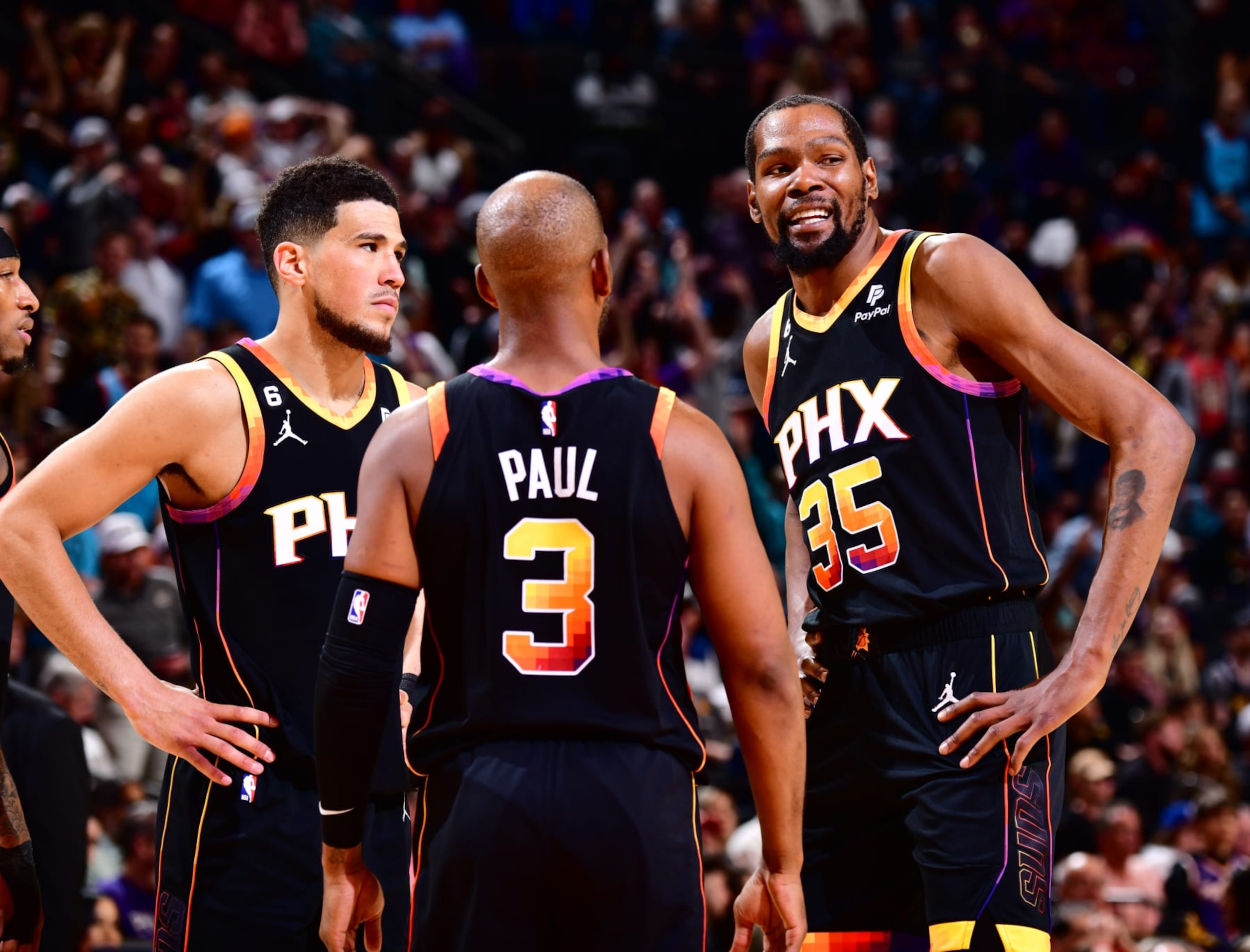 PHOENIX, AZ - APRIL 6: Devin Booker #1, Chris Paul #3 and Kevin Durant #35 of the Phoenix Suns looks on during the game on April 6, 2023 at Footprint Center in Phoenix, Arizona. NOTE TO USER: User expressly acknowledges and agrees that, by downloading and or using this photograph, user is consenting to the terms and conditions of the Getty Images License Agreement. Mandatory Copyright Notice: Copyright 2023 NBAE (Photo by Barry Gossage/NBAE via Getty Images) PHOENIX, AZ - APRIL 6: Devin Booker #1, Chris Paul #3 and Kevin Durant #35 of the Phoenix Suns looks on during the game on April 6, 2023 at Footprint Center in Phoenix, Arizona. NOTE TO USER: User expressly acknowledges and agrees that, by downloading and or using this photograph, user is consenting to the terms and conditions of the Getty Images License Agreement. Mandatory Copyright Notice: Copyright 2023 NBAE (Photo by Barry Gossage/NBAE via Getty Images)