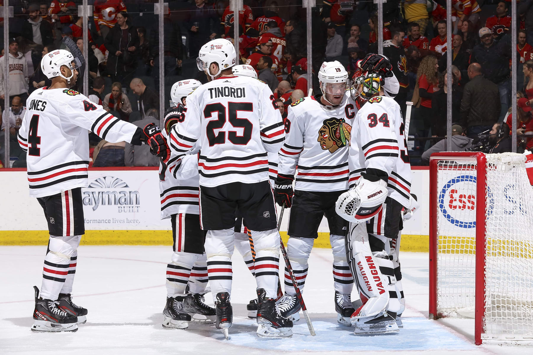 CALGARY, AB - APRIL 4: The Chicago Blackhawks celebrate on ice after a win against the Calgary Flames at Scotiabank Saddledome on April 4, 2023 in Calgary, Alberta, Canada. (Photo by Gerry Thomas/NHLI via Getty Images)