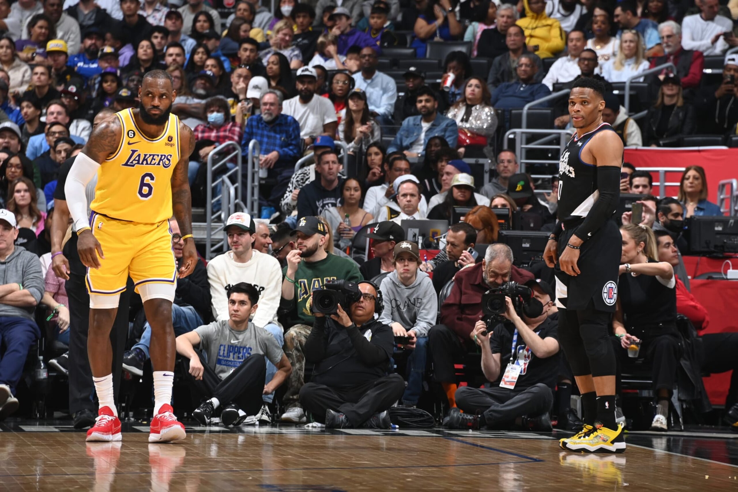 LOS ANGELES, CA - APRIL 5: LeBron James #6 of the Los Angeles Lakers and Russell Westbrook #0 of the LA Clippers look on during the game on April 5, 2023 at Crypto.Com Arena in Los Angeles, California. NOTE TO USER: User expressly acknowledges and agrees that, by downloading and/or using this Photograph, user is consenting to the terms and conditions of the Getty Images License Agreement. Mandatory Copyright Notice: Copyright 2023 NBAE (Photo by Andrew D. Bernstein/NBAE via Getty Images) LOS ANGELES, CA - APRIL 5: LeBron James #6 of the Los Angeles Lakers and Russell Westbrook #0 of the LA Clippers look on during the game on April 5, 2023 at Crypto.Com Arena in Los Angeles, California. NOTE TO USER: User expressly acknowledges and agrees that, by downloading and/or using this Photograph, user is consenting to the terms and conditions of the Getty Images License Agreement. Mandatory Copyright Notice: Copyright 2023 NBAE (Photo by Andrew D. Bernstein/NBAE via Getty Images)
