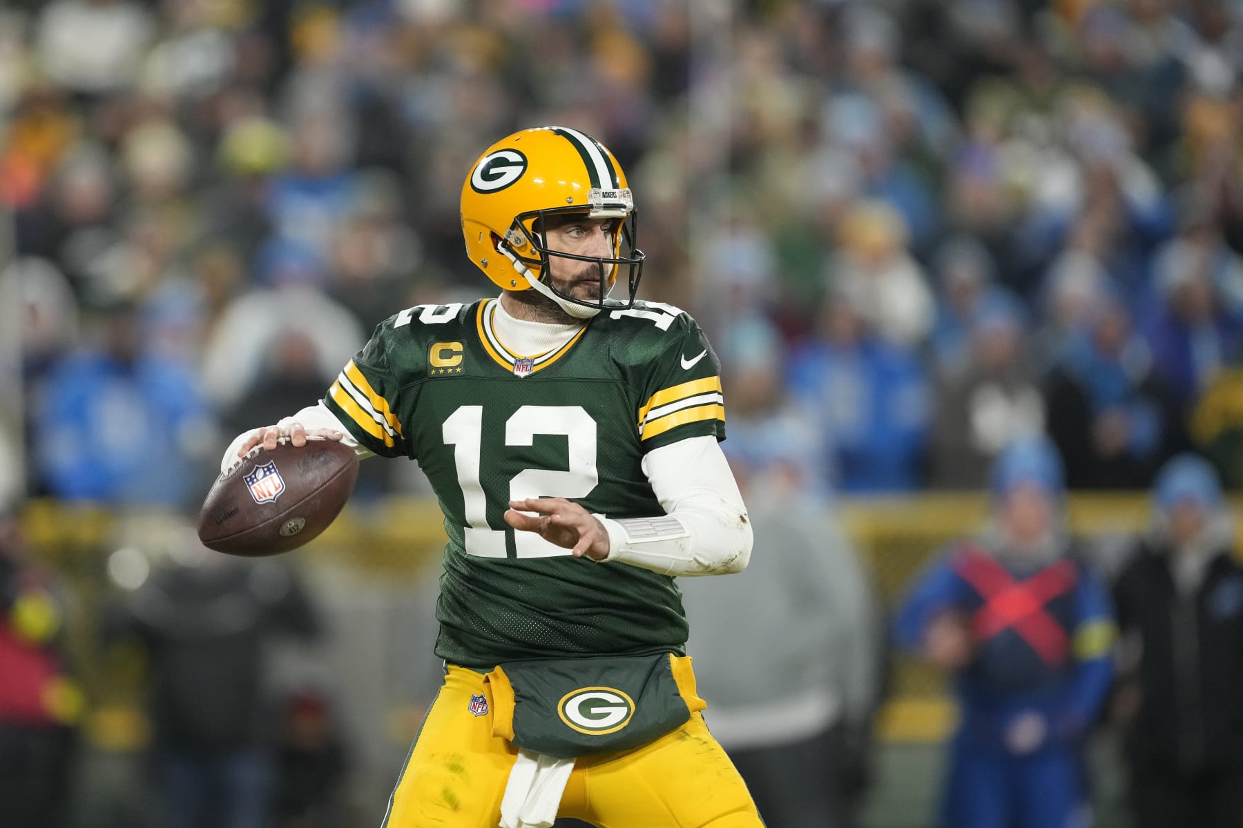 GREEN BAY, WISCONSIN - JANUARY 08: Aaron Rodgers #12 of the Green Bay Packers looks to the throw the pass against the Detroit Lions in the second half at Lambeau Field on January 08, 2023 in Green Bay, Wisconsin. (Photo by Patrick McDermott/Getty Images)