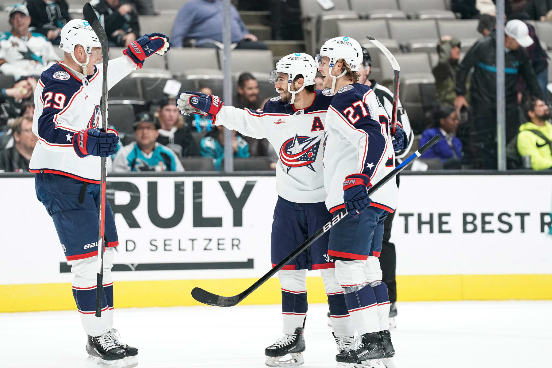 SAN JOSE, CA - MARCH 14: Johnny Gaudreau #13, Patrik Laine #29 and Adam Boqvist #27 of the Columbus Blue Jackets celebrates scoring the game-winning goal in overtime against the San Jose Sharks at SAP Center on March 14, 2023 in San Jose, California. (Photo by Kavin Mistry/NHLI via Getty Images)