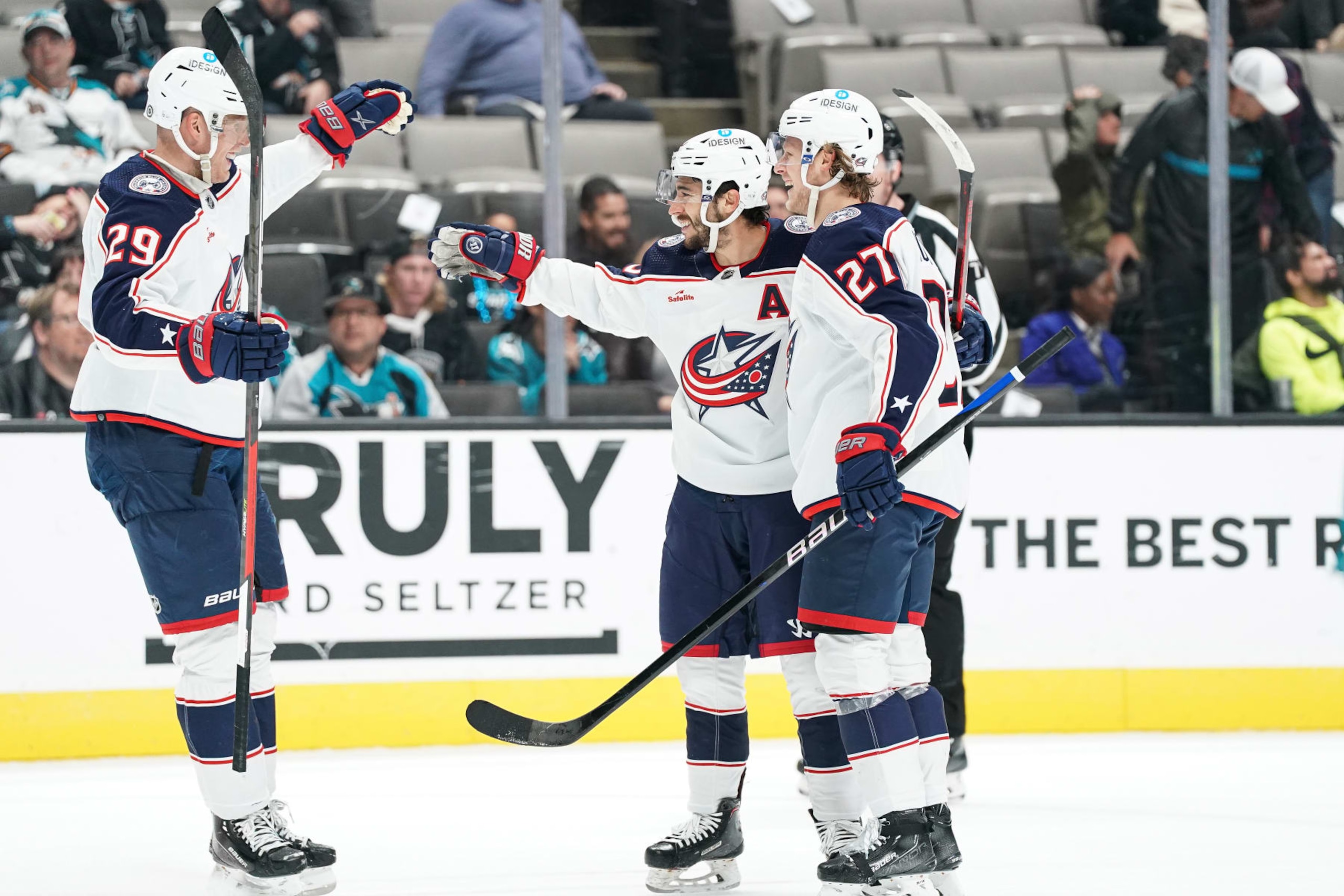 SAN JOSE, CA - MARCH 14: Johnny Gaudreau #13, Patrik Laine #29 and Adam Boqvist #27 of the Columbus Blue Jackets celebrates scoring the game-winning goal in overtime against the San Jose Sharks at SAP Center on March 14, 2023 in San Jose, California. (Photo by Kavin Mistry/NHLI via Getty Images)