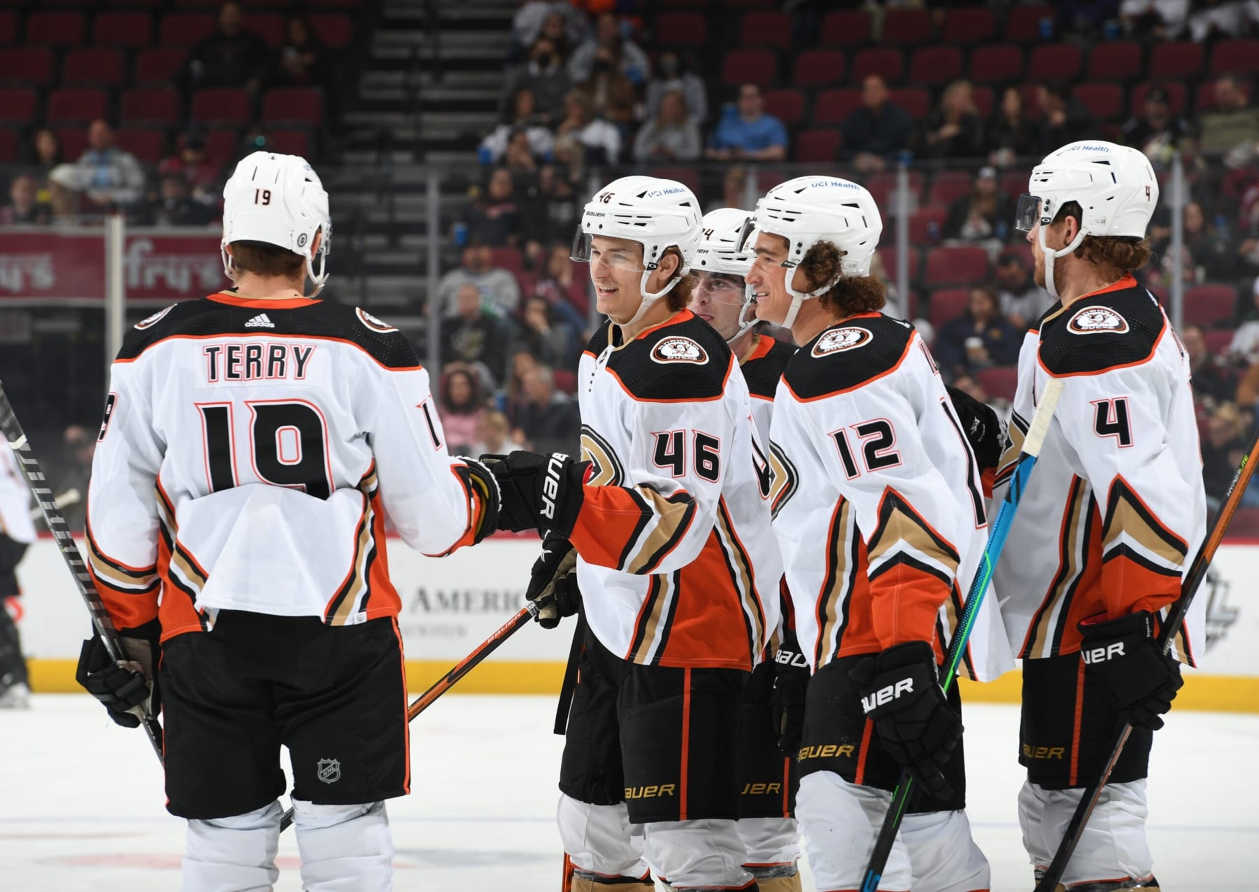 GLENDALE, ARIZONA - APRIL 01: Trevor Zegras #46 of the Anaheim Ducks celebrates with Troy Terry #19 and Sonny Milano #12 after scoring a goal against the Arizona Coyotes at Gila River Arena on April 01, 2022 in Glendale, Arizona. (Photo by Norm Hall/NHLI via Getty Images)