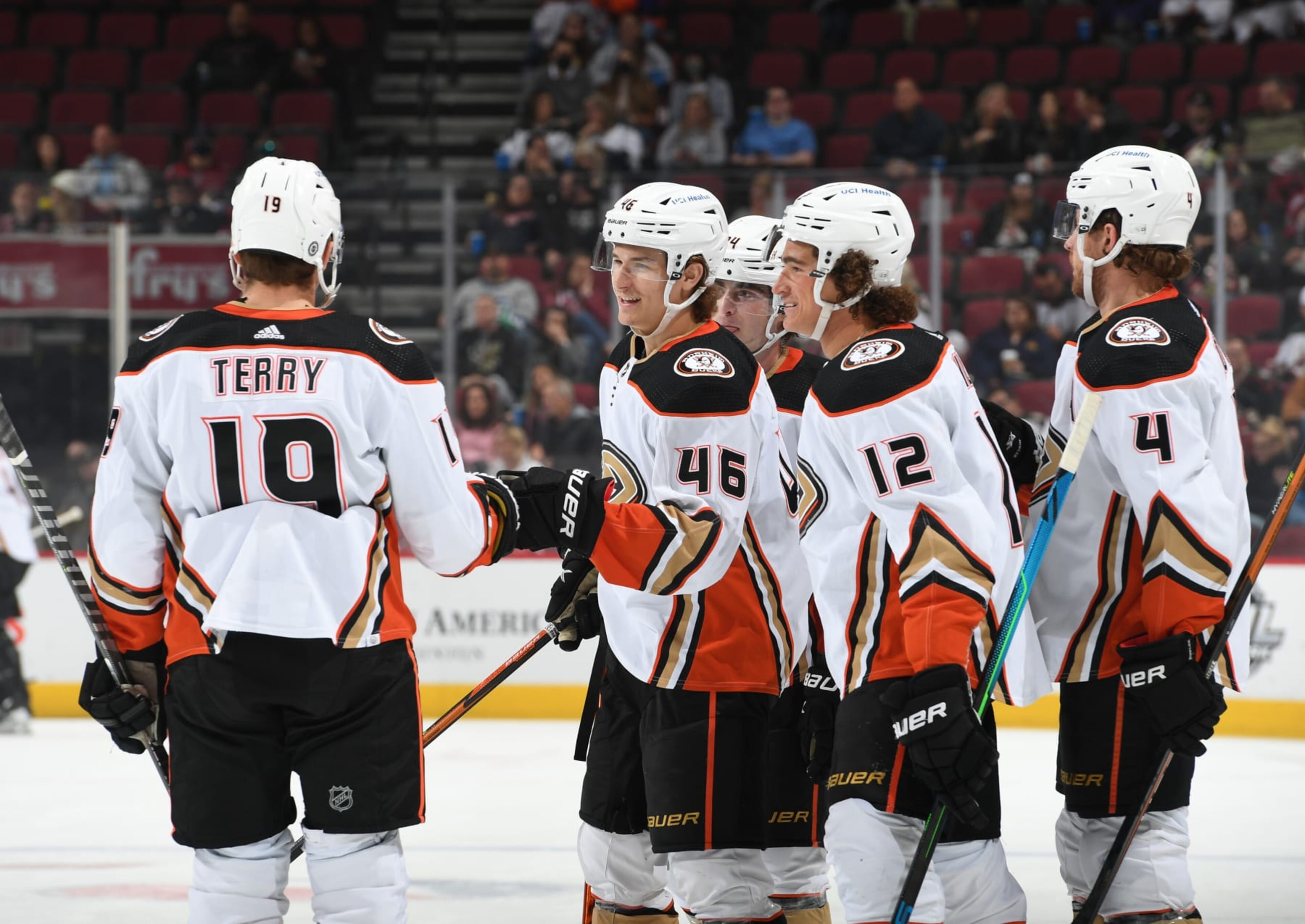GLENDALE, ARIZONA - APRIL 01: Trevor Zegras #46 of the Anaheim Ducks celebrates with Troy Terry #19 and Sonny Milano #12 after scoring a goal against the Arizona Coyotes at Gila River Arena on April 01, 2022 in Glendale, Arizona. (Photo by Norm Hall/NHLI via Getty Images)