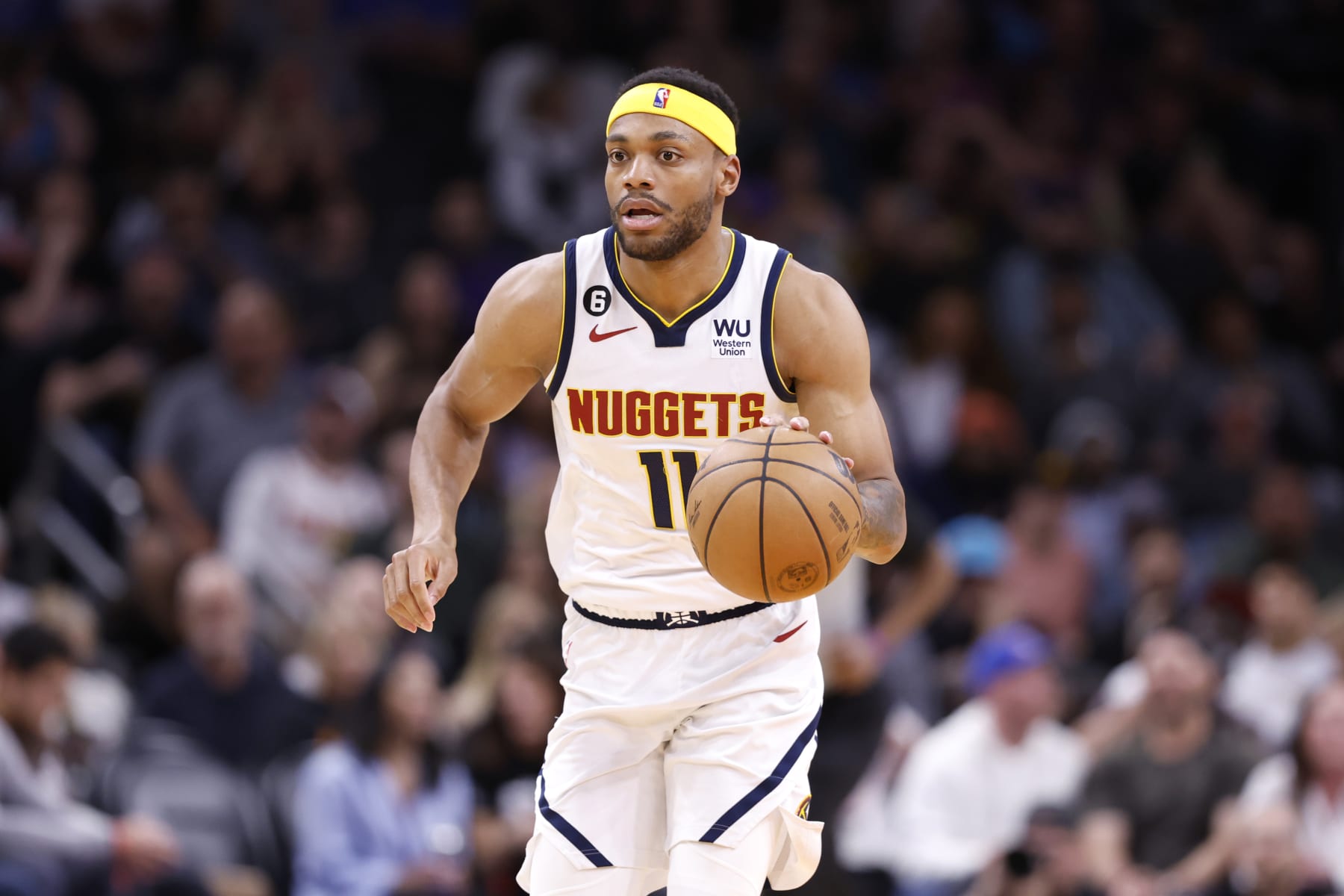 PHOENIX, ARIZONA - APRIL 06: Bruce Brown #11 of the Denver Nuggets dribbles the ball during the game against the Phoenix Suns at Footprint Center on April 06, 2023 in Phoenix, Arizona. The Suns beat the Nuggets 119-115. NOTE TO USER: User expressly acknowledges and agrees that, by downloading and or using this photograph, User is consenting to the terms and conditions of the Getty Images License Agreement.  (Photo by Chris Coduto/Getty Images)