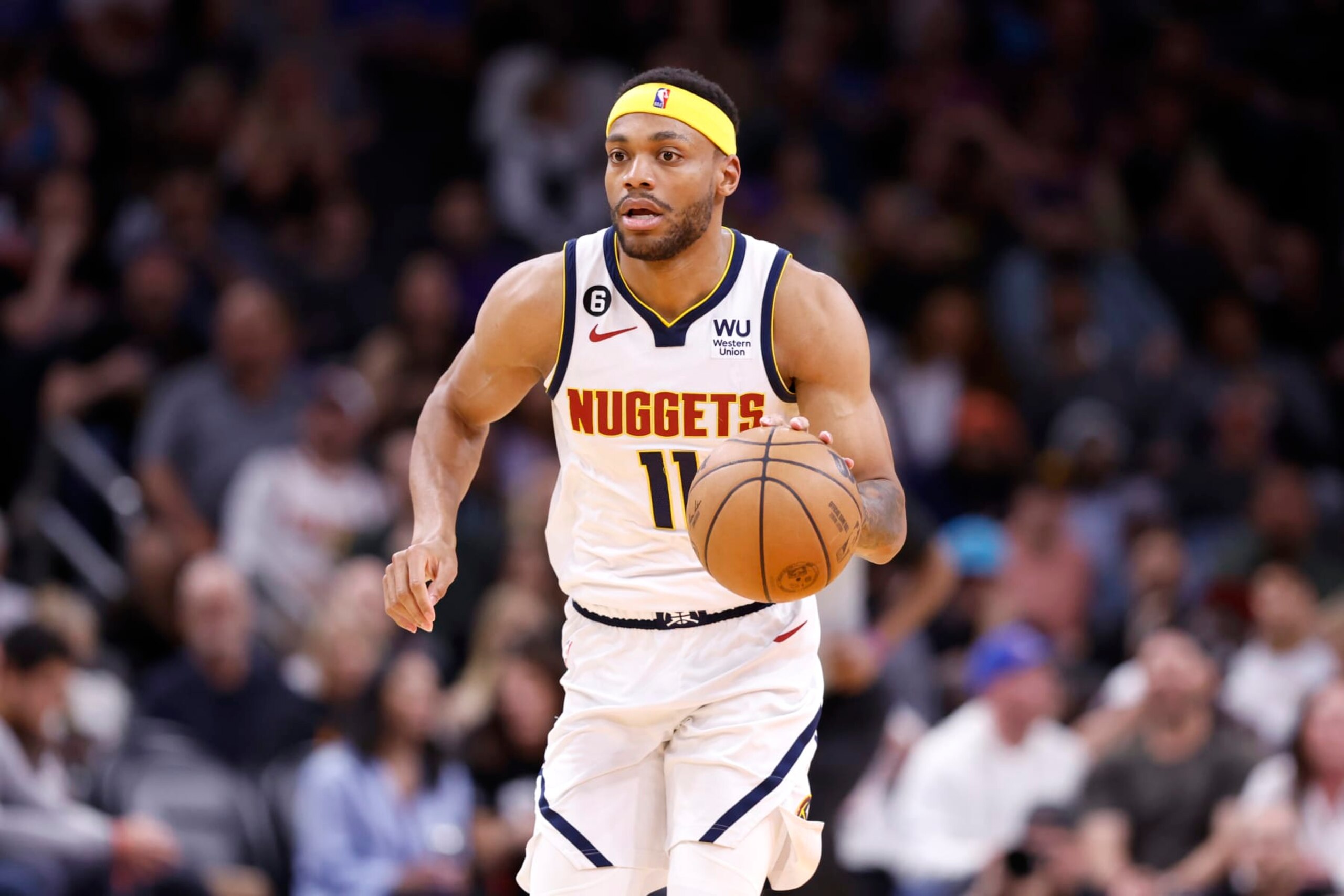 PHOENIX, ARIZONA - APRIL 06: Bruce Brown #11 of the Denver Nuggets dribbles the ball during the game against the Phoenix Suns at Footprint Center on April 06, 2023 in Phoenix, Arizona. The Suns beat the Nuggets 119-115. NOTE TO USER: User expressly acknowledges and agrees that, by downloading and or using this photograph, User is consenting to the terms and conditions of the Getty Images License Agreement.  (Photo by Chris Coduto/Getty Images)
