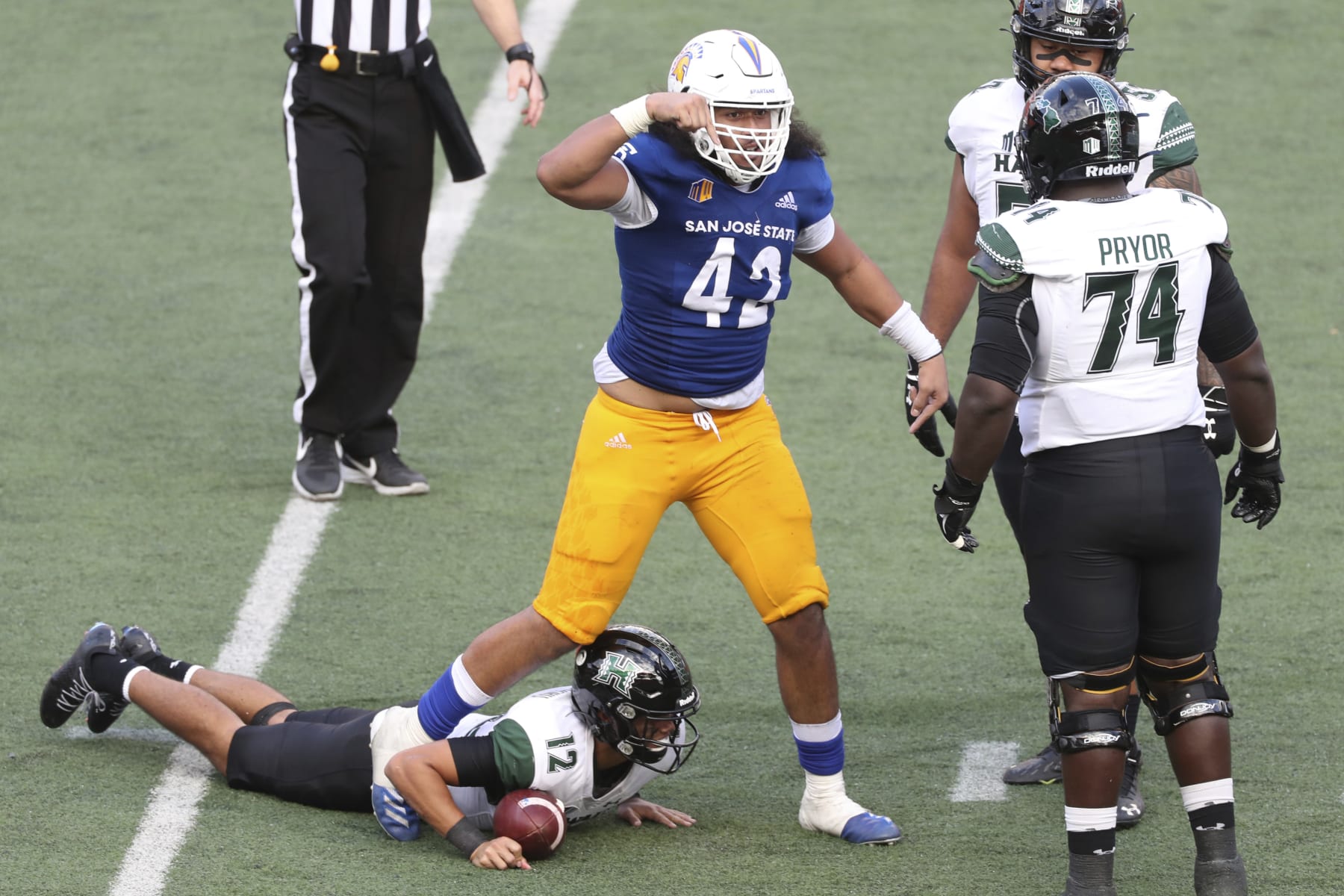 San Jose State defensive end Viliami Fehoko (42) reacts after sacking Hawaii quarterback Chevan Cordeiro (12) during an NCAA college football game Saturday, Dec. 5, 2020, in Honolulu. (AP Photo/Marco Garcia)