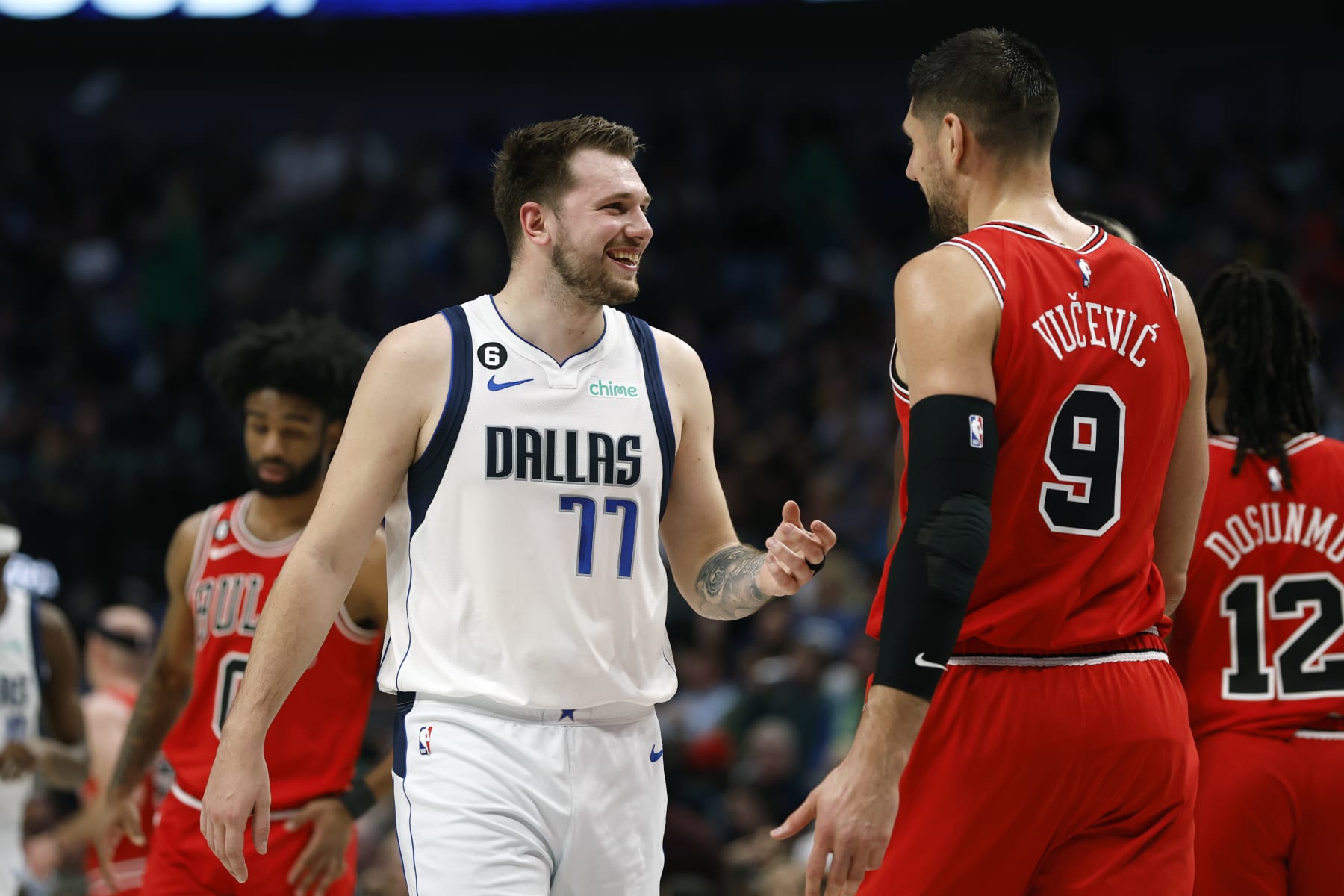 DALLAS, TEXAS - APRIL 07: Luka Doncic #77 of the Dallas Mavericks talks to Nikola Vucevic #9 of the Chicago Bulls during a timeout in the first half at American Airlines Center on April 07, 2023 in Dallas, Texas. NOTE TO USER: User expressly acknowledges and agrees that, by downloading and or using this photograph, User is consenting to the terms and conditions of the Getty Images License Agreement. (Photo by Tim Heitman/Getty Images)