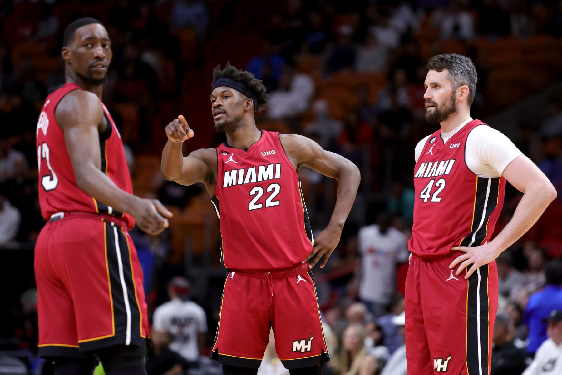 MIAMI, FLORIDA - MARCH 15: Bam Adebayo #13, Jimmy Butler #22 and Kevin Love #42 of the Miami Heat look on during the second quarter of the game against the Memphis Grizzlies at Miami-Dade Arena on March 15, 2023 in Miami, Florida. NOTE TO USER: User expressly acknowledges and agrees that, by downloading and or using this photograph, User is consenting to the terms and conditions of the Getty Images License Agreement. (Photo by Megan Briggs/Getty Images)