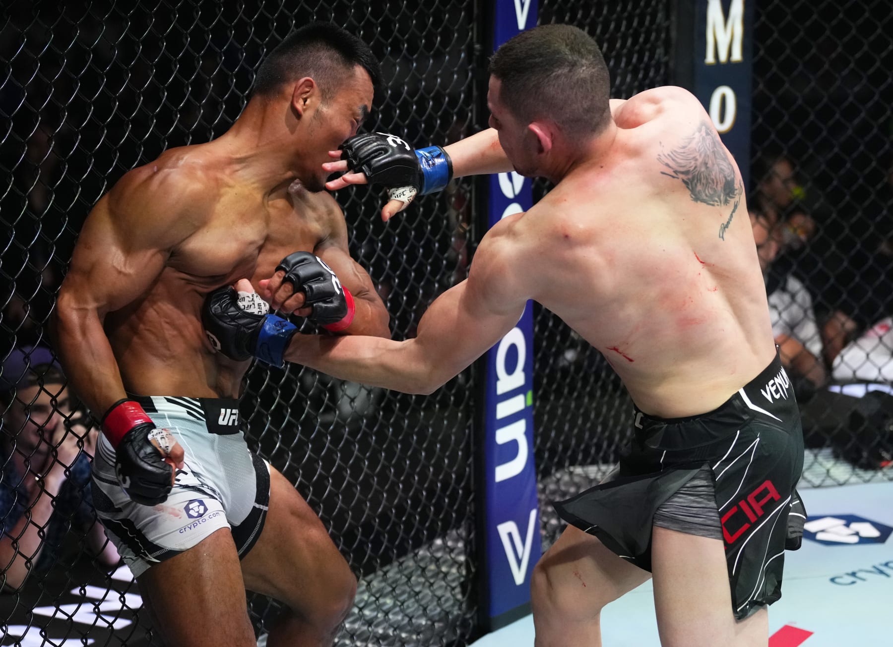 MIAMI, FLORIDA - APRIL 08: (R-L) Steve Garcia punches Shayilan Nuerdanbieke of China in a featherweight fight during the UFC 287 event at Kaseya Center on April 08, 2023 in Miami, Florida. (Photo by Jeff Bottari/Zuffa LLC via Getty Images)