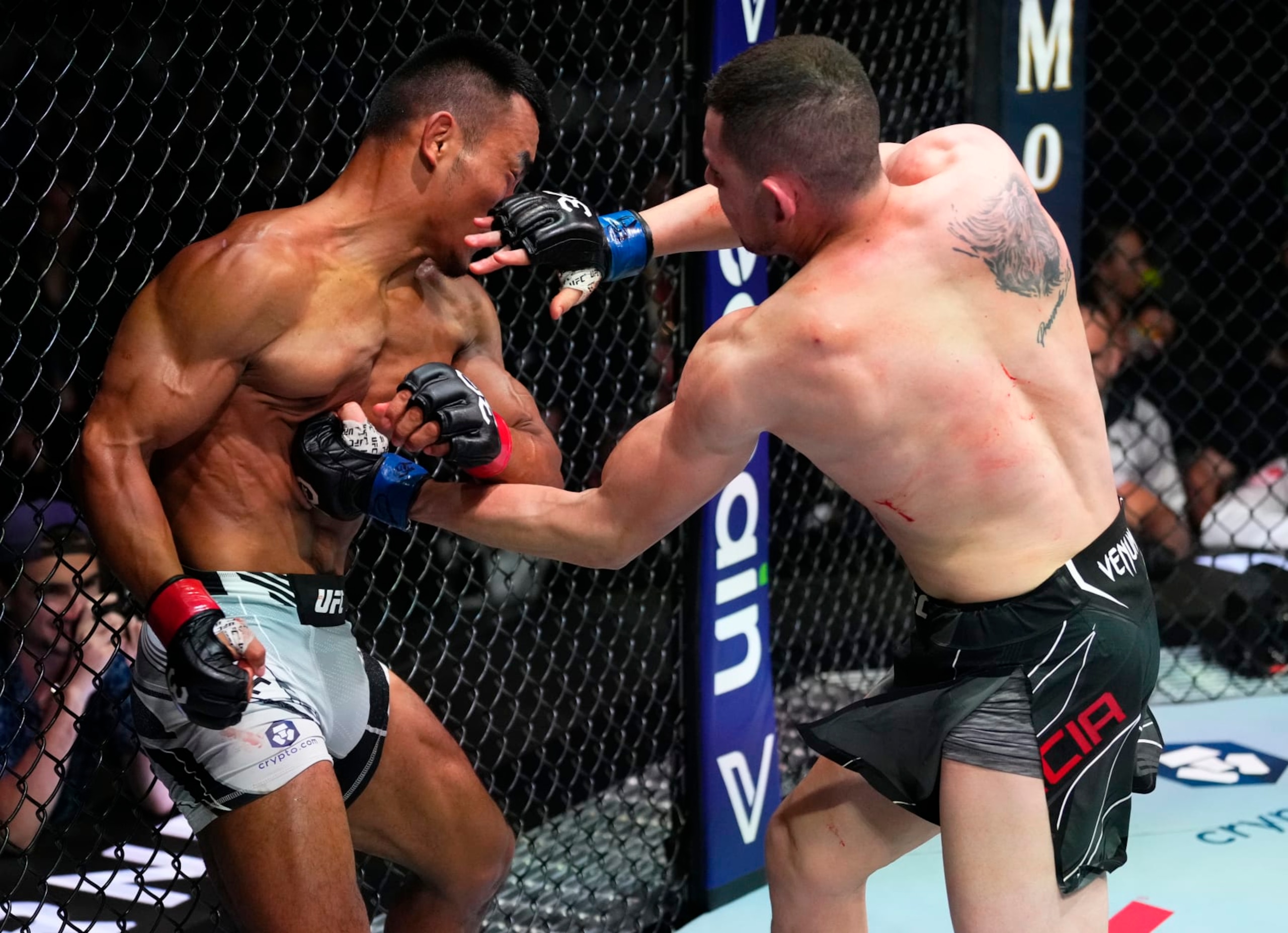 MIAMI, FLORIDA - APRIL 08: (R-L) Steve Garcia punches Shayilan Nuerdanbieke of China in a featherweight fight during the UFC 287 event at Kaseya Center on April 08, 2023 in Miami, Florida. (Photo by Jeff Bottari/Zuffa LLC via Getty Images)