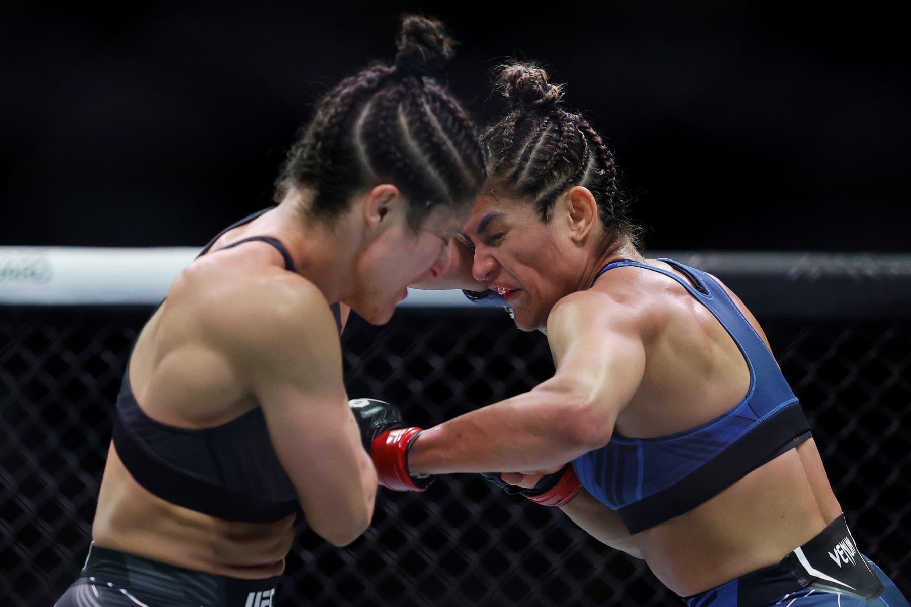 MIAMI, FLORIDA - APRIL 08: Loopy Godinez (L) of Mexico exchanges strikes with Cynthia Calvillo in their strawweight bout during UFC 287 at Kaseya Center on April 08, 2023 in Miami, Florida. (Photo by Carmen Mandato/Getty Images)