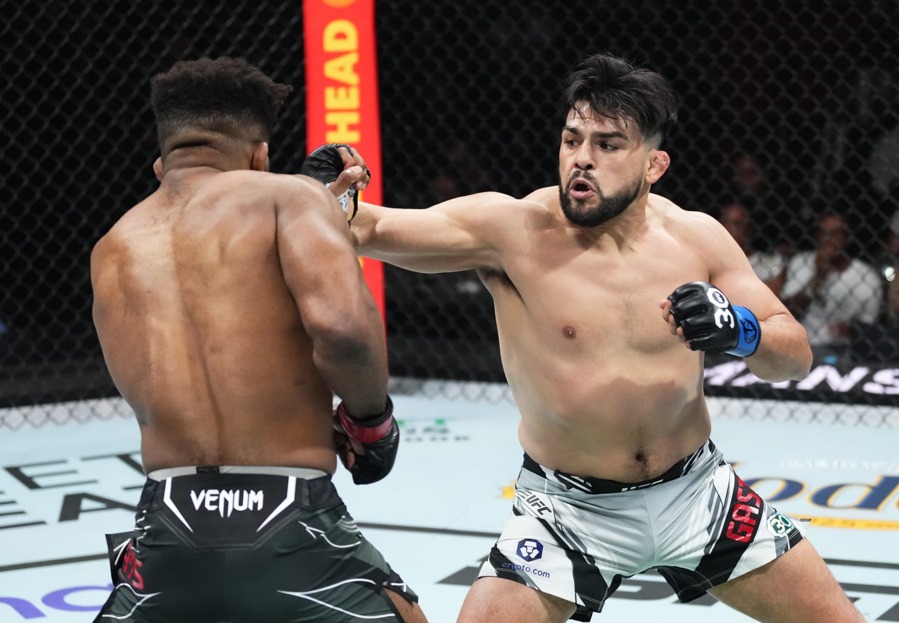 MIAMI, FLORIDA - APRIL 08: (R-L) Kelvin Gastelum punches Chris Curtis in a middleweight fight during the UFC 287 event at Kaseya Center on April 08, 2023 in Miami, Florida. (Photo by Jeff Bottari/Zuffa LLC via Getty Images)