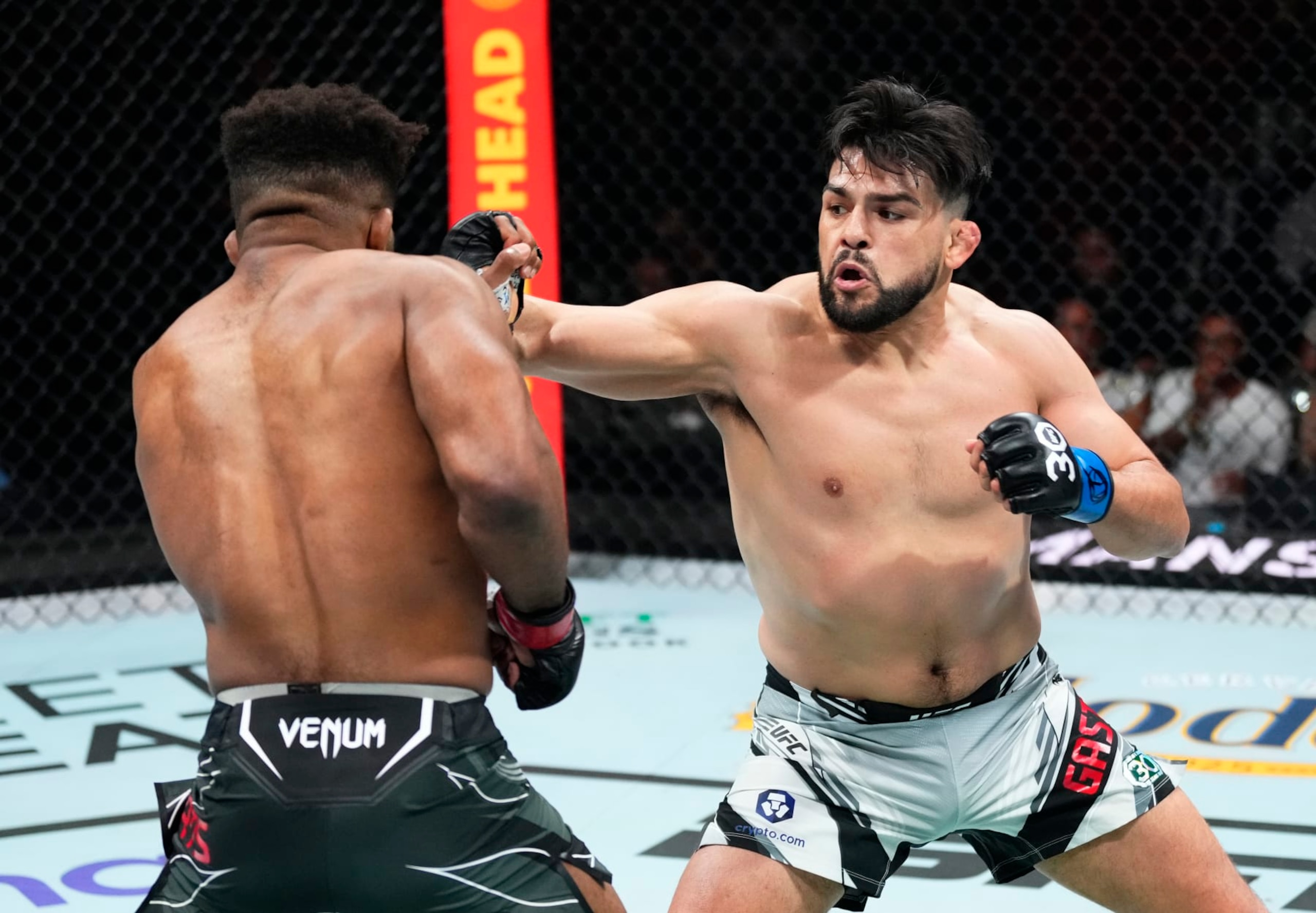 MIAMI, FLORIDA - APRIL 08: (R-L) Kelvin Gastelum punches Chris Curtis in a middleweight fight during the UFC 287 event at Kaseya Center on April 08, 2023 in Miami, Florida. (Photo by Jeff Bottari/Zuffa LLC via Getty Images)