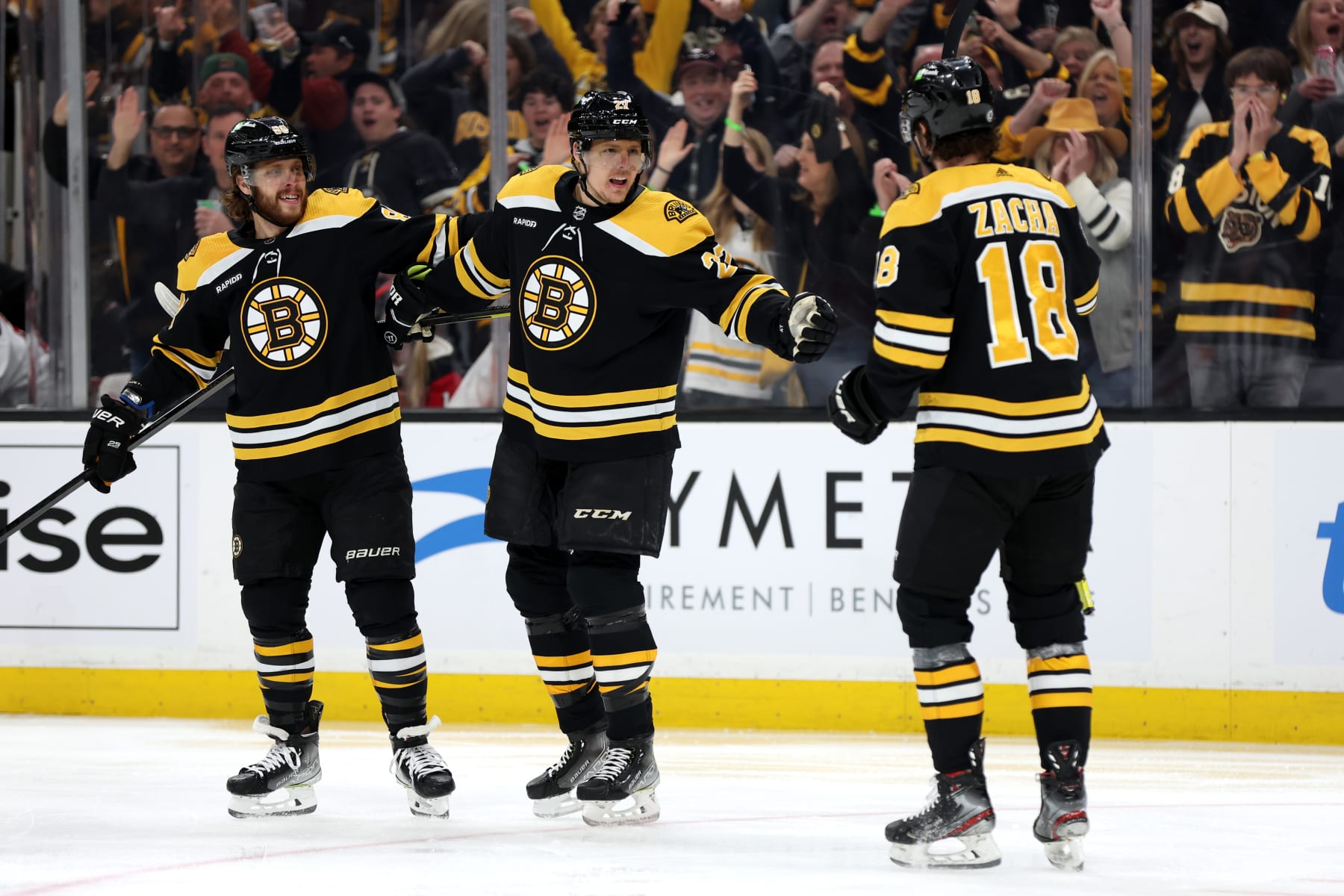 BOSTON, MASSACHUSETTS - APRIL 08: Pavel Zacha #18 of the Boston Bruins celebrates with Hampus Lindholm #27 and David Pastrnak #88 after scoring a goal against the New Jersey Devils during the first period at TD Garden on April 08, 2023 in Boston, Massachusetts. (Photo by Maddie Meyer/Getty Images)