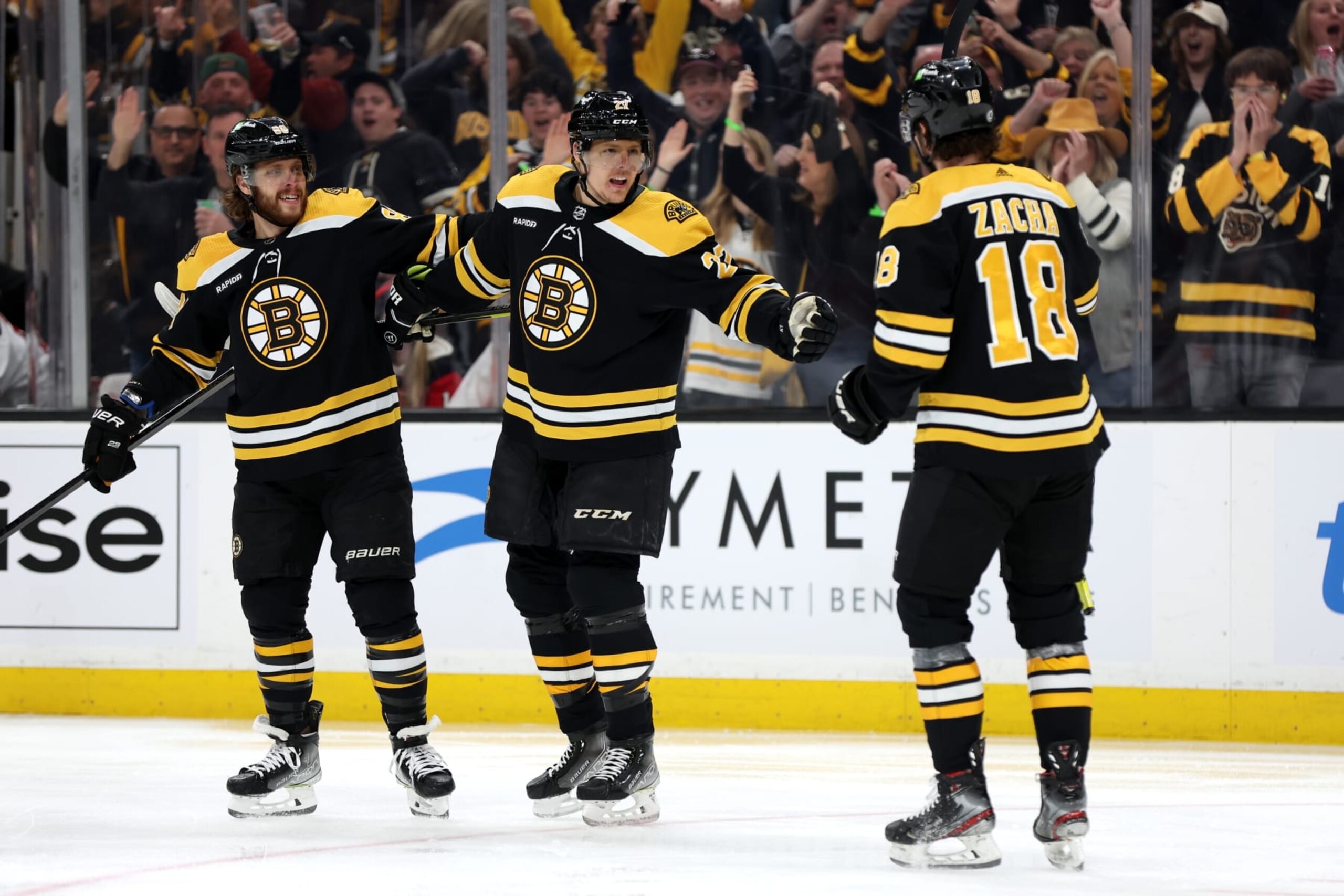 BOSTON, MASSACHUSETTS - APRIL 08: Pavel Zacha #18 of the Boston Bruins celebrates with Hampus Lindholm #27 and David Pastrnak #88 after scoring a goal against the New Jersey Devils during the first period at TD Garden on April 08, 2023 in Boston, Massachusetts. (Photo by Maddie Meyer/Getty Images)
