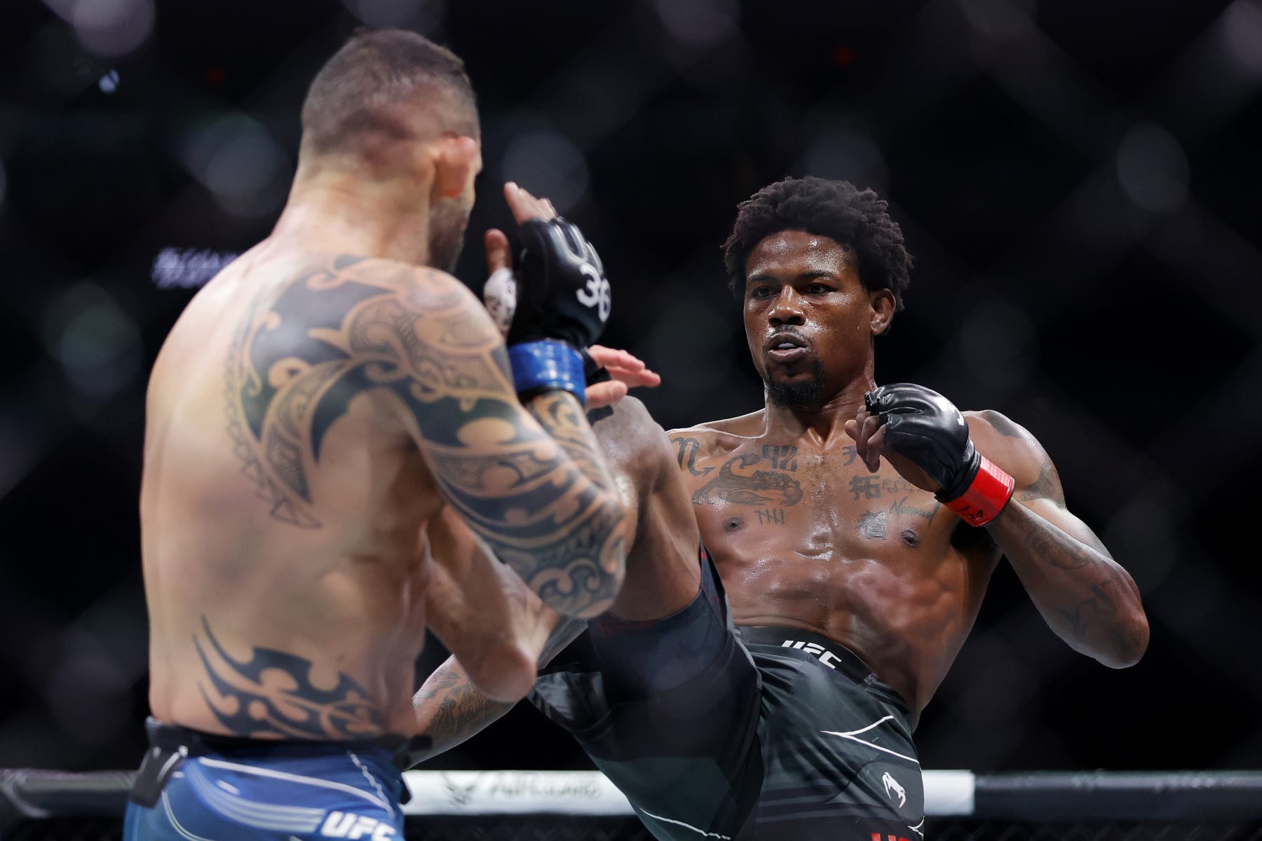 MIAMI, FLORIDA - APRIL 08: Kevin Holland (R) kicks Santiago Ponzinibbio of Argentina in their welterweight bout during UFC 287 at Kaseya Center on April 08, 2023 in Miami, Florida. (Photo by Carmen Mandato/Getty Images)