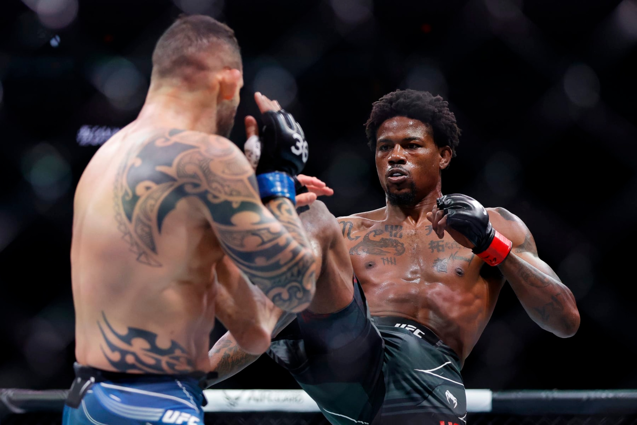 MIAMI, FLORIDA - APRIL 08: Kevin Holland (R) kicks Santiago Ponzinibbio of Argentina in their welterweight bout during UFC 287 at Kaseya Center on April 08, 2023 in Miami, Florida. (Photo by Carmen Mandato/Getty Images)