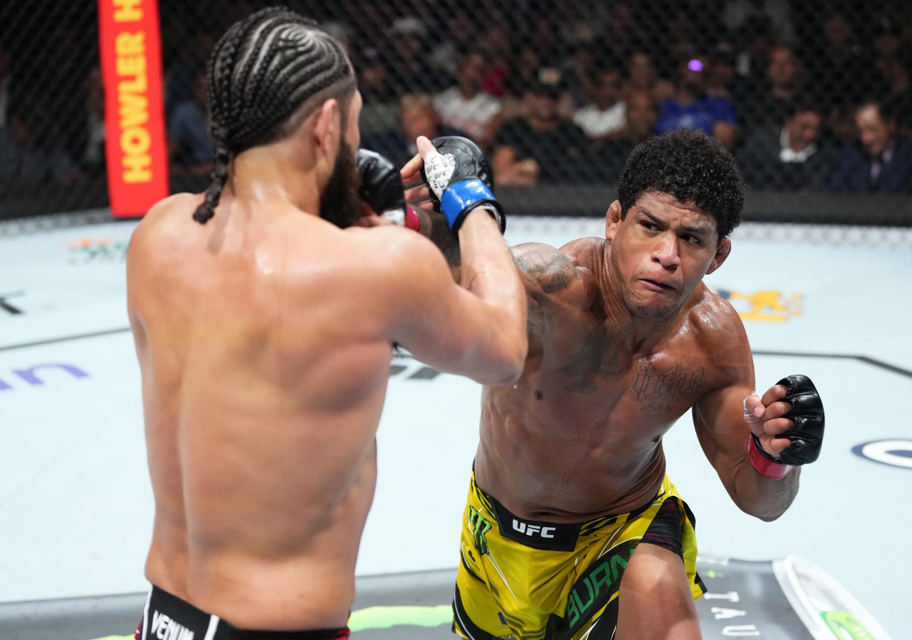 MIAMI, FLORIDA - APRIL 08: (R-L) Gilbert Burns of Brazil punches Jorge Masvidal in a welterweight fight during the UFC 287 event at Kaseya Center on April 08, 2023 in Miami, Florida. (Photo by Jeff Bottari/Zuffa LLC via Getty Images)