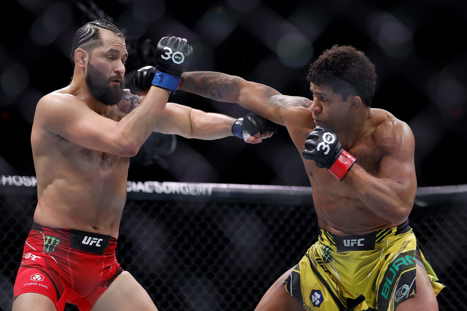 MIAMI, FLORIDA - APRIL 08: Gilbert Burns (R) of Brazil punches Jorge Masvidal in their welterweight bout during UFC 287 at Kaseya Center on April 08, 2023 in Miami, Florida. (Photo by Carmen Mandato/Getty Images)