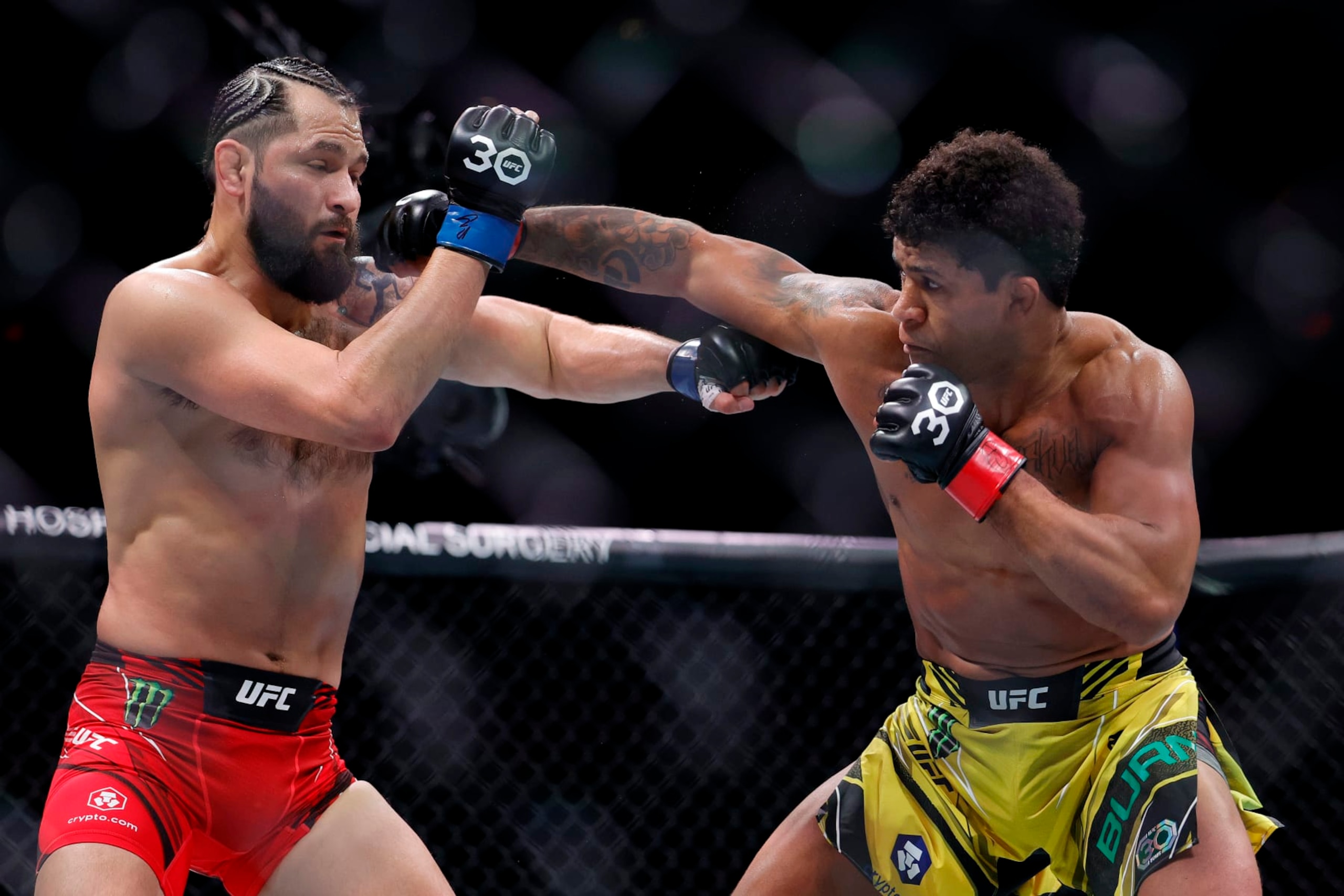 MIAMI, FLORIDA - APRIL 08: Gilbert Burns (R) of Brazil punches Jorge Masvidal in their welterweight bout during UFC 287 at Kaseya Center on April 08, 2023 in Miami, Florida. (Photo by Carmen Mandato/Getty Images)