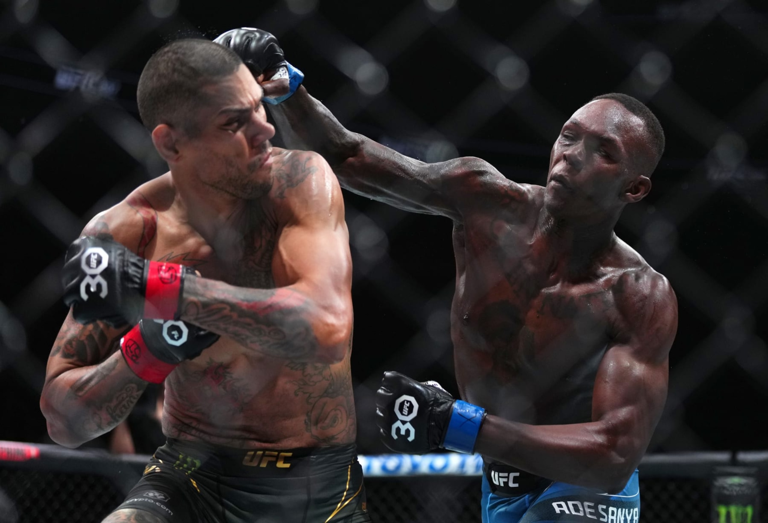 MIAMI, FLORIDA - APRIL 08: (R-L) Israel Adesanya of Nigeria punches Alex Pereira of Brazil in the UFC middleweight championship fight during the UFC 287 event at Kaseya Center on April 08, 2023 in Miami, Florida. (Photo by Cooper Neill/Zuffa LLC via Getty Images)