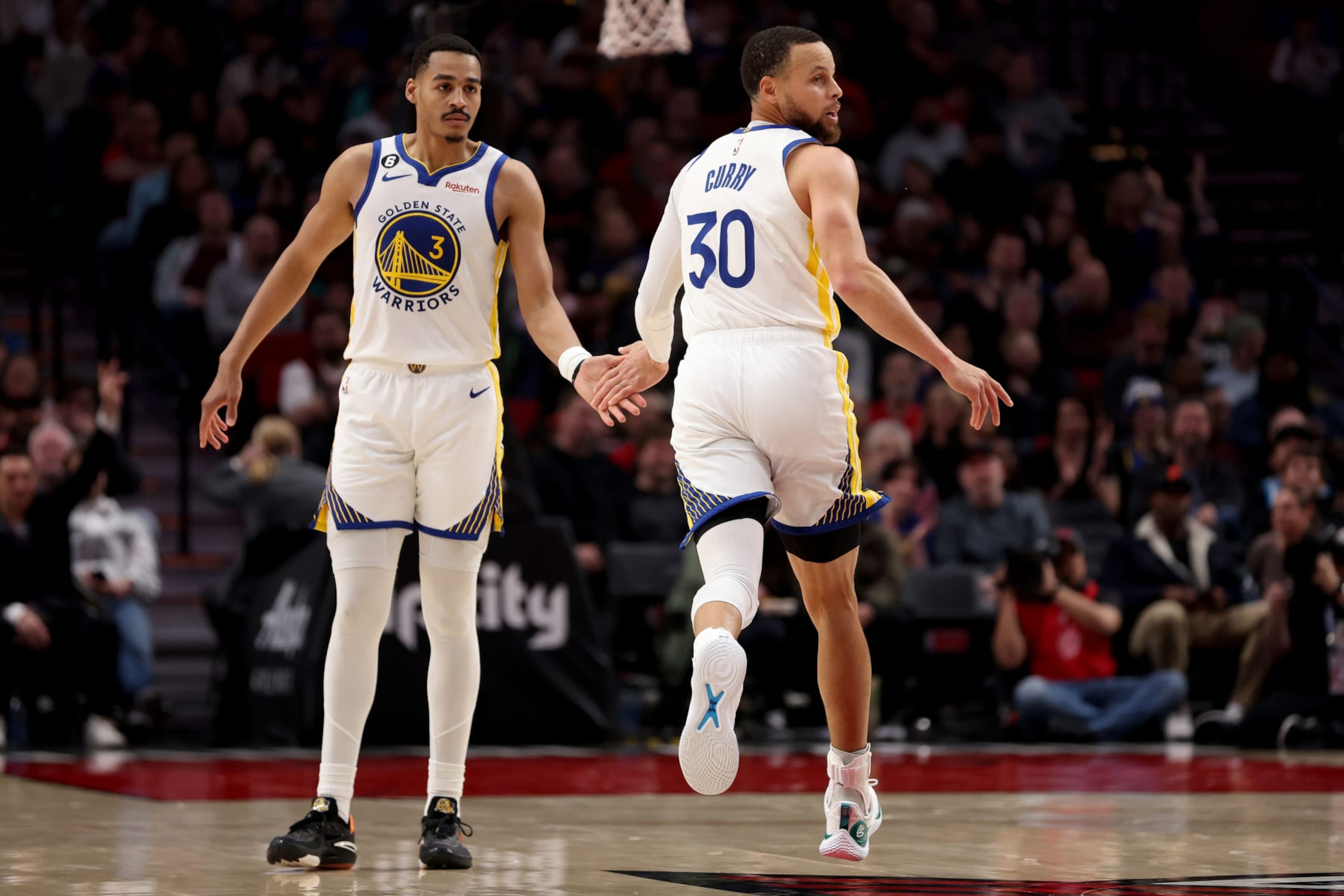 PORTLAND, OREGON - APRIL 09: Jordan Poole #3 and Stephen Curry #30 of the Golden State Warriors react during the first quarter against the Portland Trail Blazers at Moda Center on April 09, 2023 in Portland, Oregon. NOTE TO USER: User expressly acknowledges and agrees that, by downloading and/or using this Photograph, user is consenting to the terms and conditions of the Getty Images License Agreement. (Photo by Steph Chambers/Getty Images)