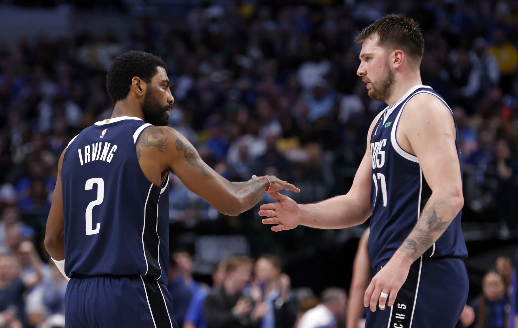DALLAS, TX - FEBRUARY 26 : Kyrie Irving #2 and teammate Luka Doncic #77 of the Dallas Mavericks shake hands during a game against the Los Angeles Lakers at American Airlines Center on February 26, 2023 in Dallas, Texas. NOTE TO USER: User expressly acknowledges and agrees that, by downloading and or using this photograph, User is consenting to the terms and conditions of the Getty Images License Agreement. (Photo by Ron Jenkins/Getty Images)