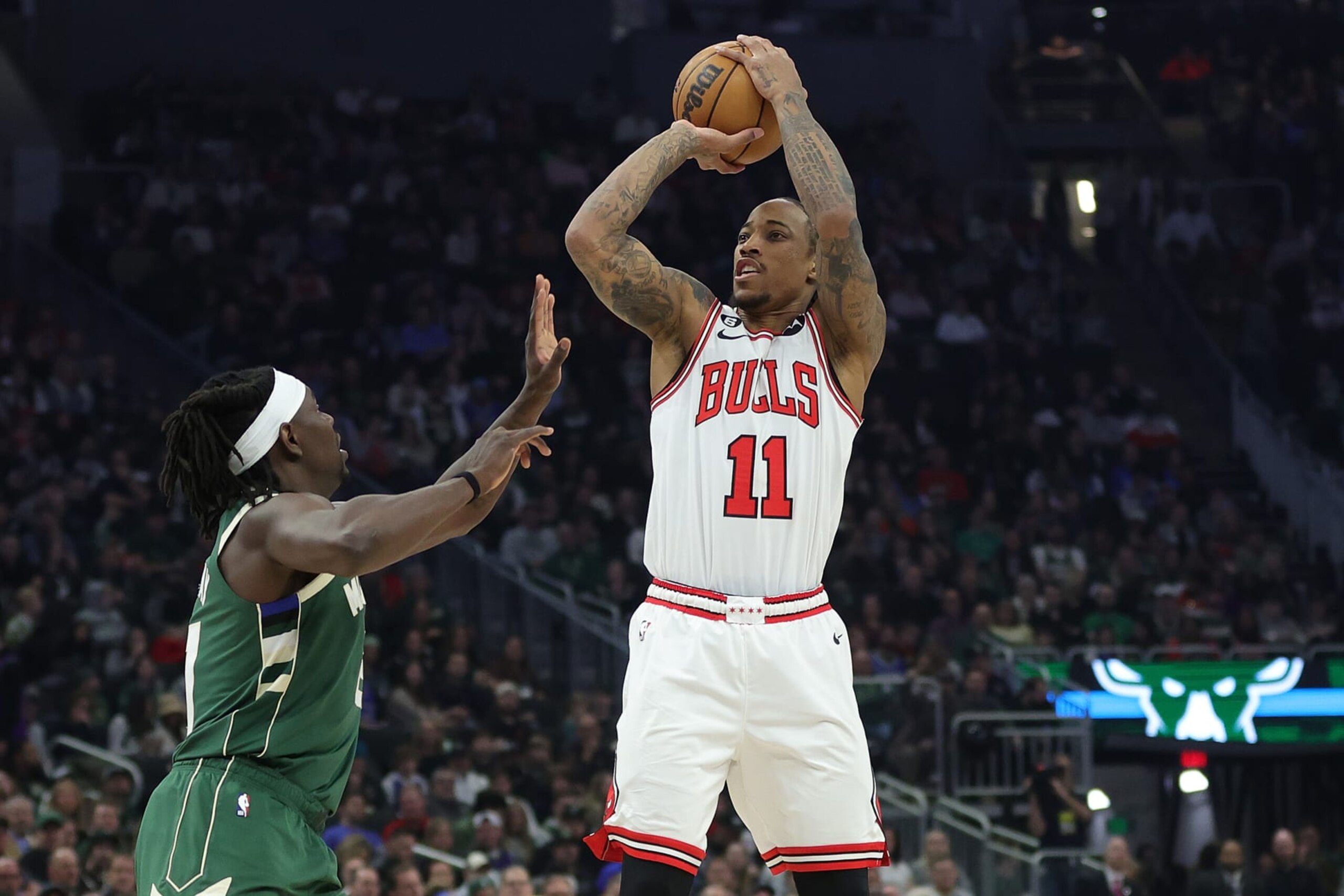 MILWAUKEE, WISCONSIN - APRIL 05: DeMar DeRozan #11 of the Chicago Bulls shoots over Jrue Holiday #21 of the Milwaukee Bucks during the first half of a game at Fiserv Forum on April 05, 2023 in Milwaukee, Wisconsin. NOTE TO USER: User expressly acknowledges and agrees that, by downloading and or using this photograph, User is consenting to the terms and conditions of the Getty Images License Agreement. (Photo by Stacy Revere/Getty Images)