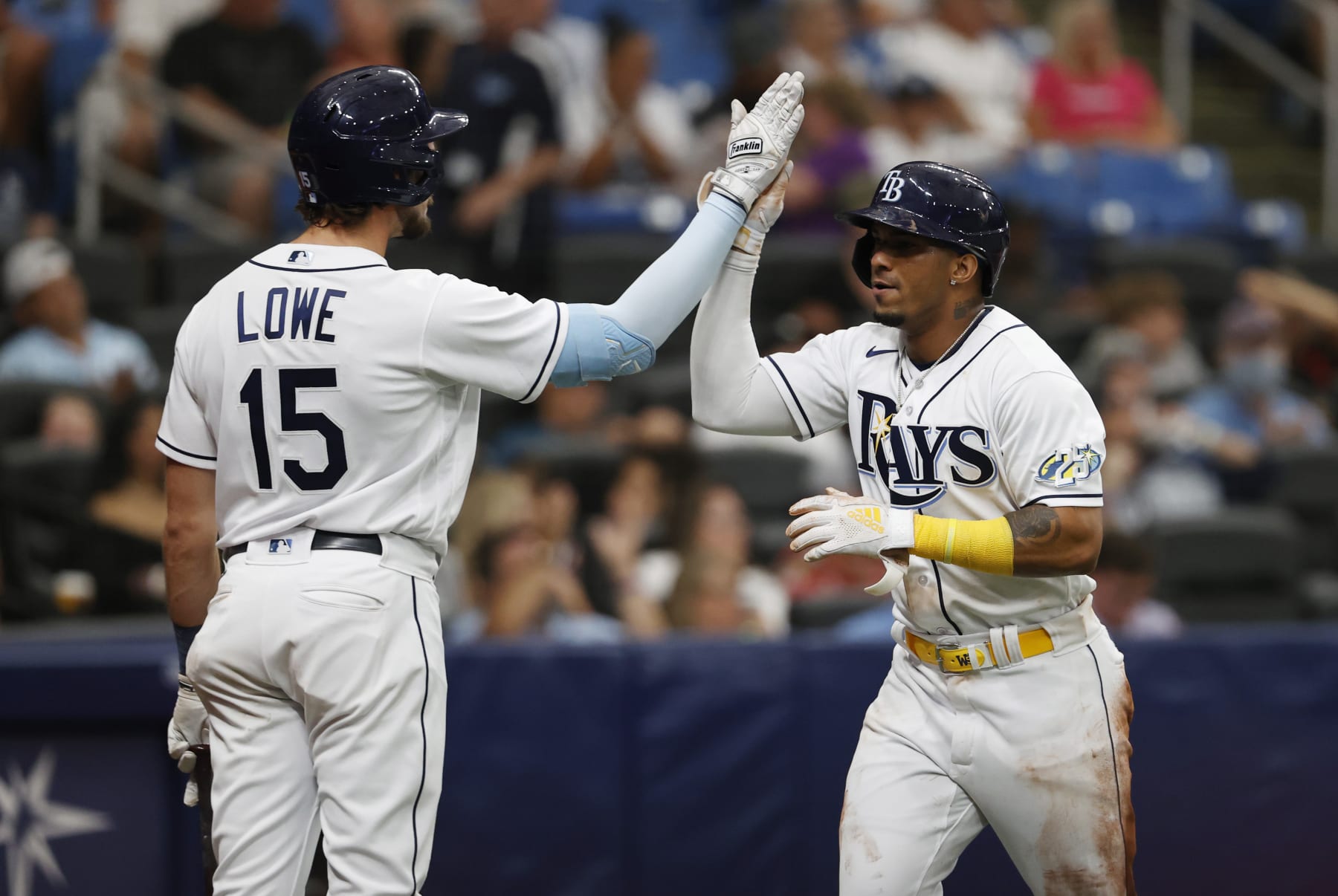 Tampa Bay Rays' Wander Franco, right, celebrates with teammate Josh Lowe after scoring against the Detroit Tigers during the third inning of a baseball game Saturday, April 1, 2023, in St. Petersburg, Fla. (AP Photo/Scott Audette)